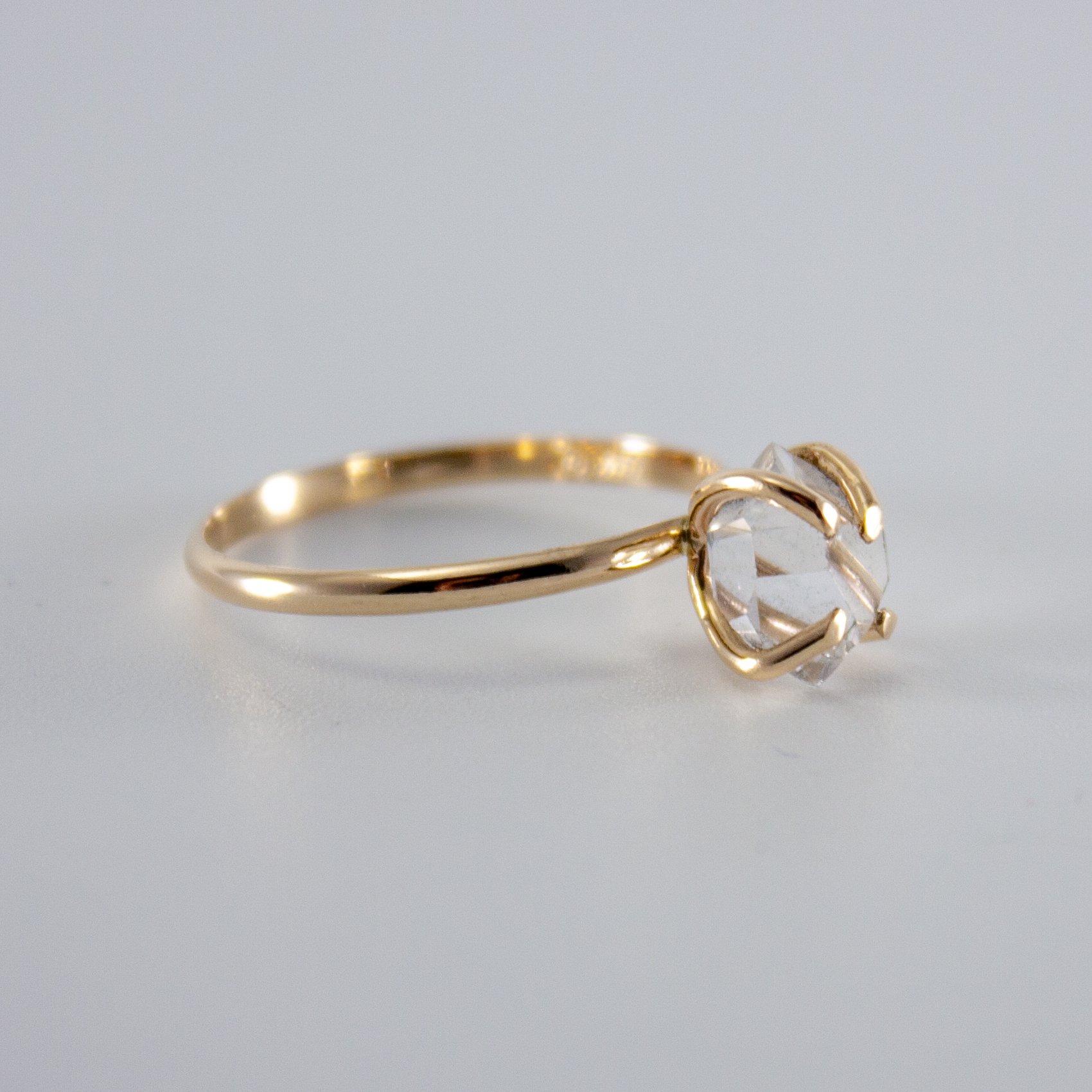 A stunning Raw Herkimer Diamond set in a 14k gold filled prong ring, showcasing its natural brilliance and unique shape.