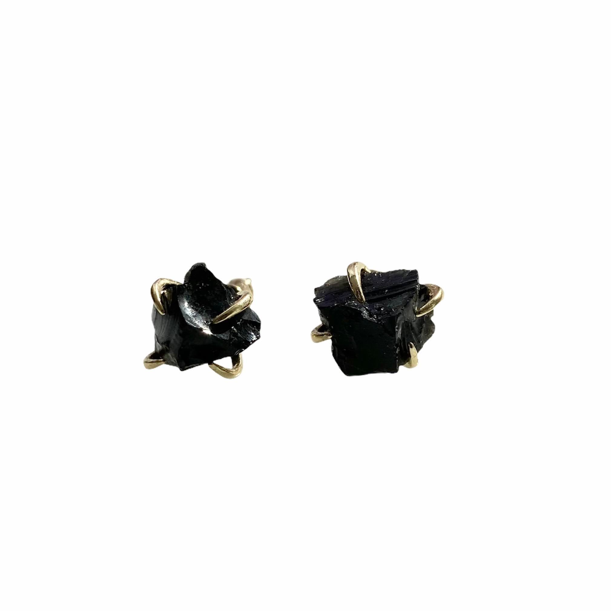 A pair of gold plated raw crystal nugget claw studs showcasing unique crystal designs.