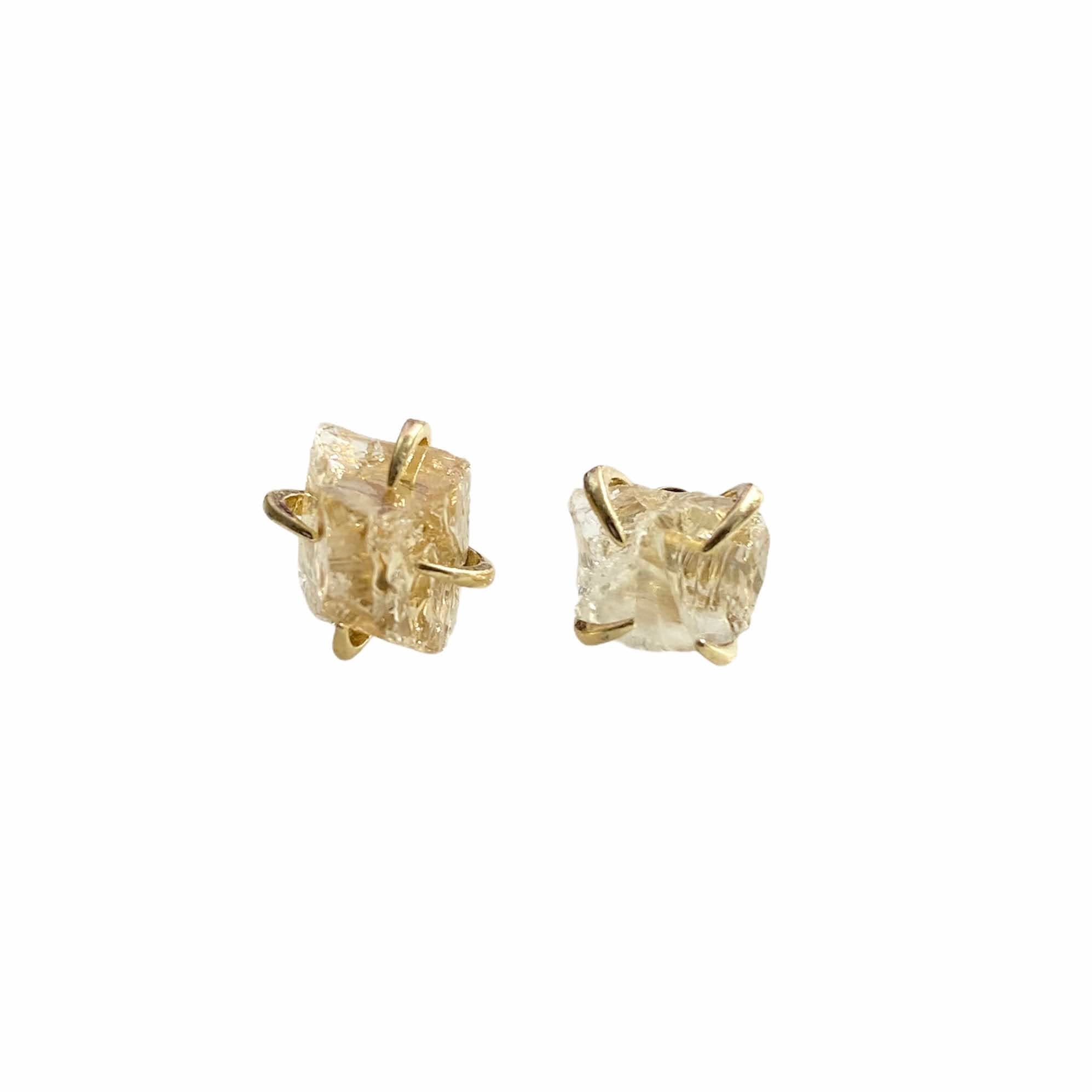 A pair of gold plated raw crystal nugget claw studs showcasing unique crystal designs.