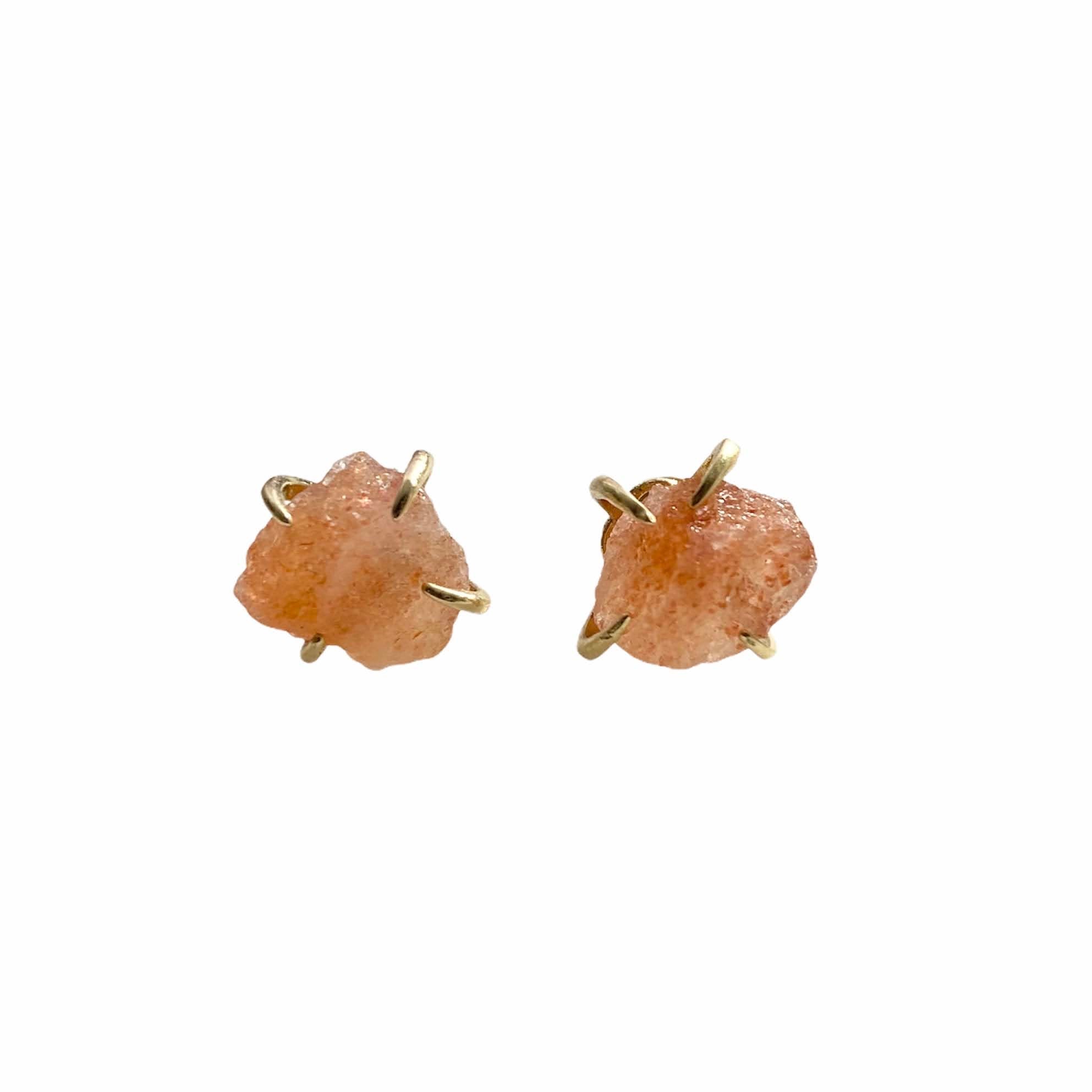 A pair of gold plated raw crystal nugget claw studs showcasing unique crystal designs.