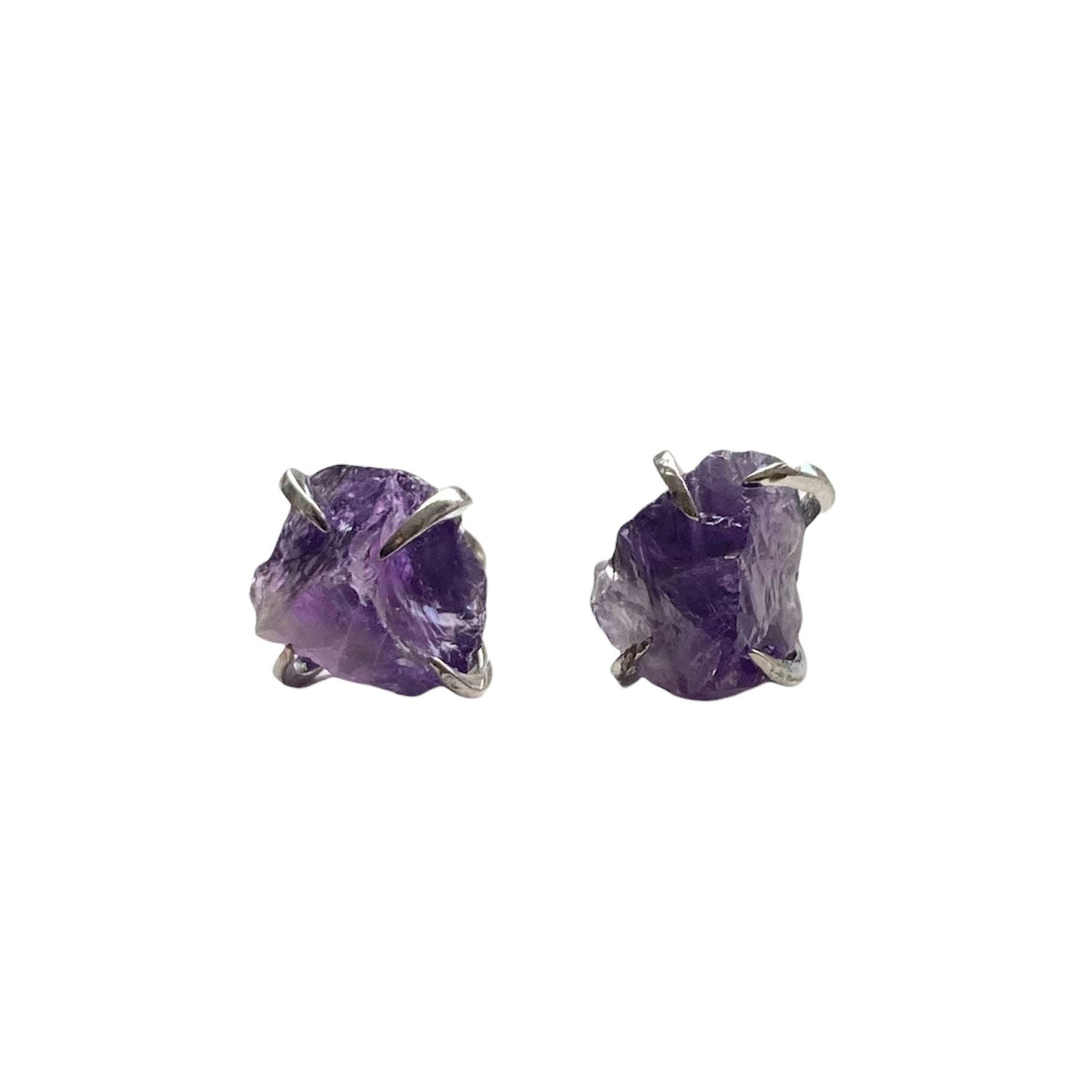 A pair of silver plated raw crystal nugget claw studs featuring various crystals like amethyst and rose quartz, showcasing their unique design.