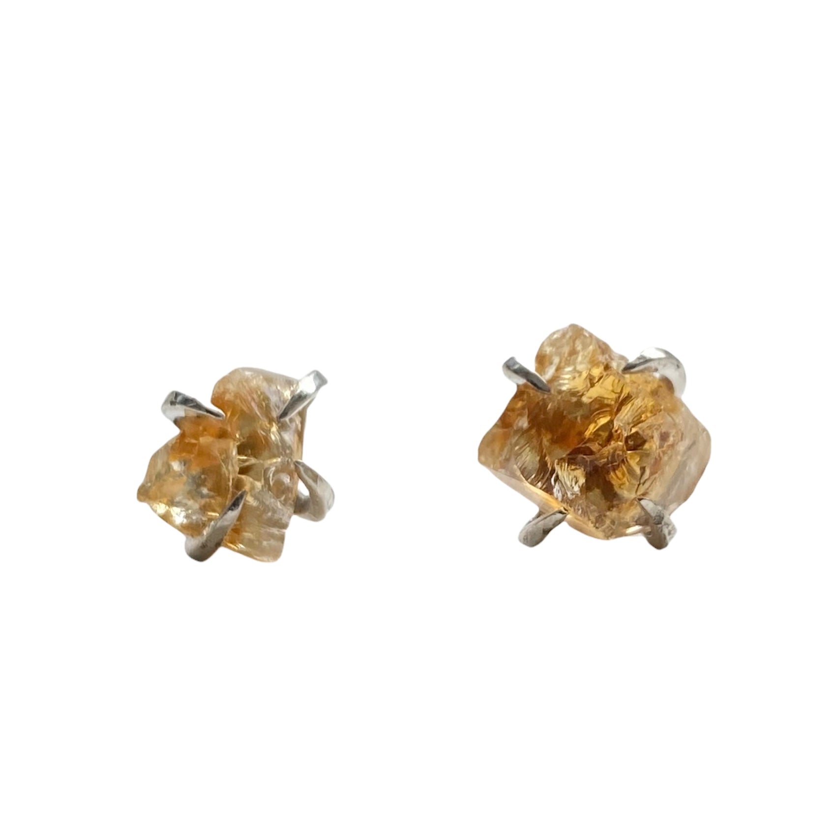 A pair of silver plated raw crystal nugget claw studs featuring various crystals like amethyst and rose quartz, showcasing their unique design.