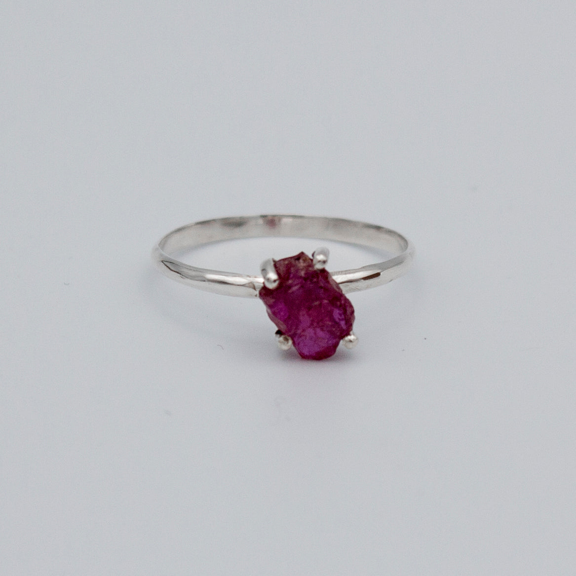 A beautiful Raw Ruby Four Prong Sterling Silver Ring showcasing natural raw rubies set in a secure four prong design on a sleek sterling silver band.