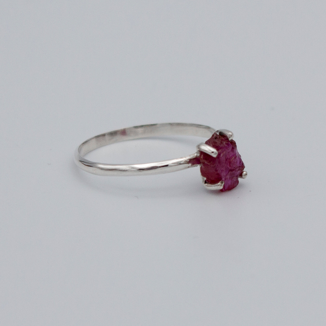 A beautiful Raw Ruby Four Prong Sterling Silver Ring showcasing natural raw rubies set in a secure four prong design on a sleek sterling silver band.