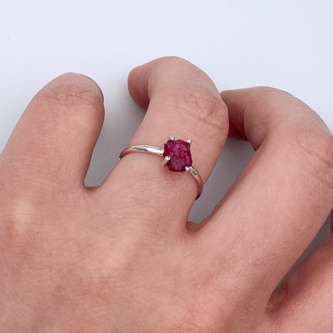 A beautiful Raw Ruby Four Prong Sterling Silver Ring showcasing natural raw rubies set in a secure four prong design on a sleek sterling silver band.