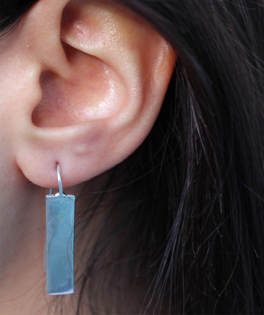 Stylish rectangular drop earrings made of brass and silver, featuring a unique design perfect for festivals and everyday wear.