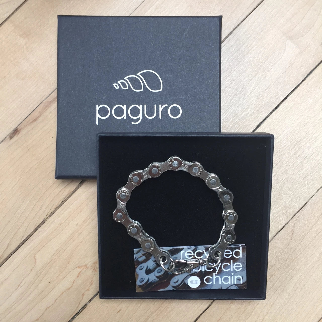 A stylish Recycled Bike Chain Bracelet made from upcycled bike chains, showcasing its unique design and eco-friendly materials.