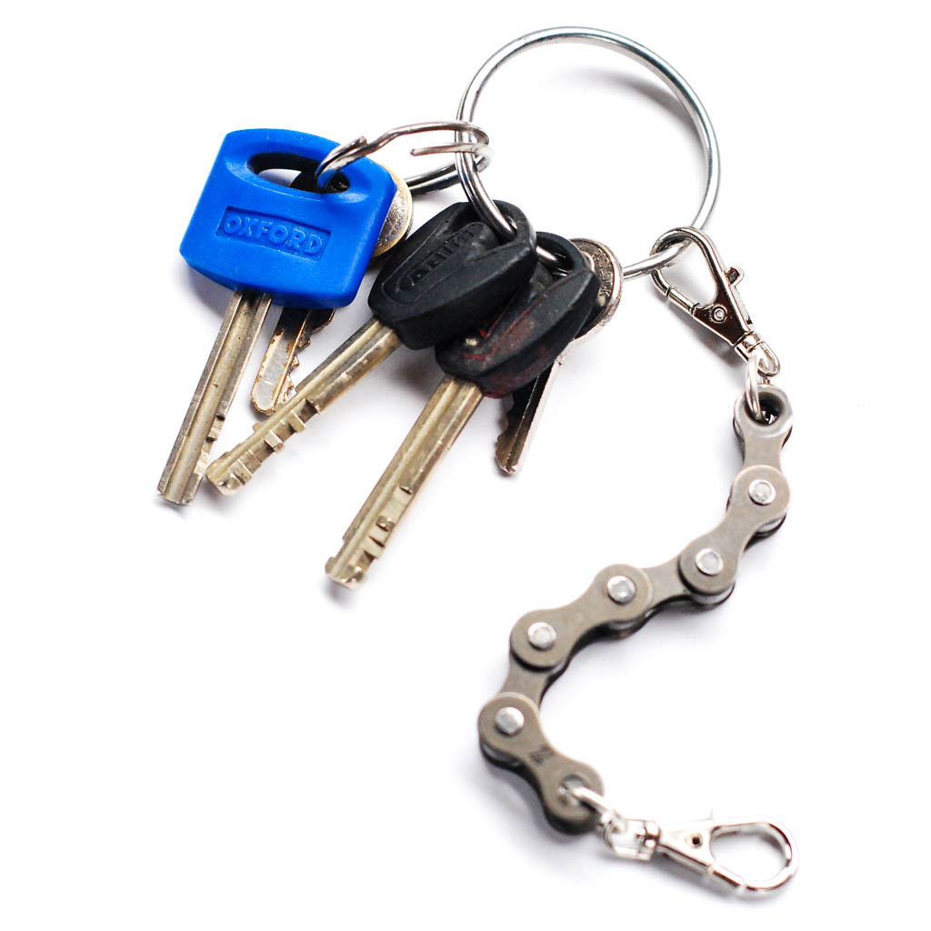 A handmade vegan keyring made from recycled bike chains, featuring a clasp and keyring for versatile use.