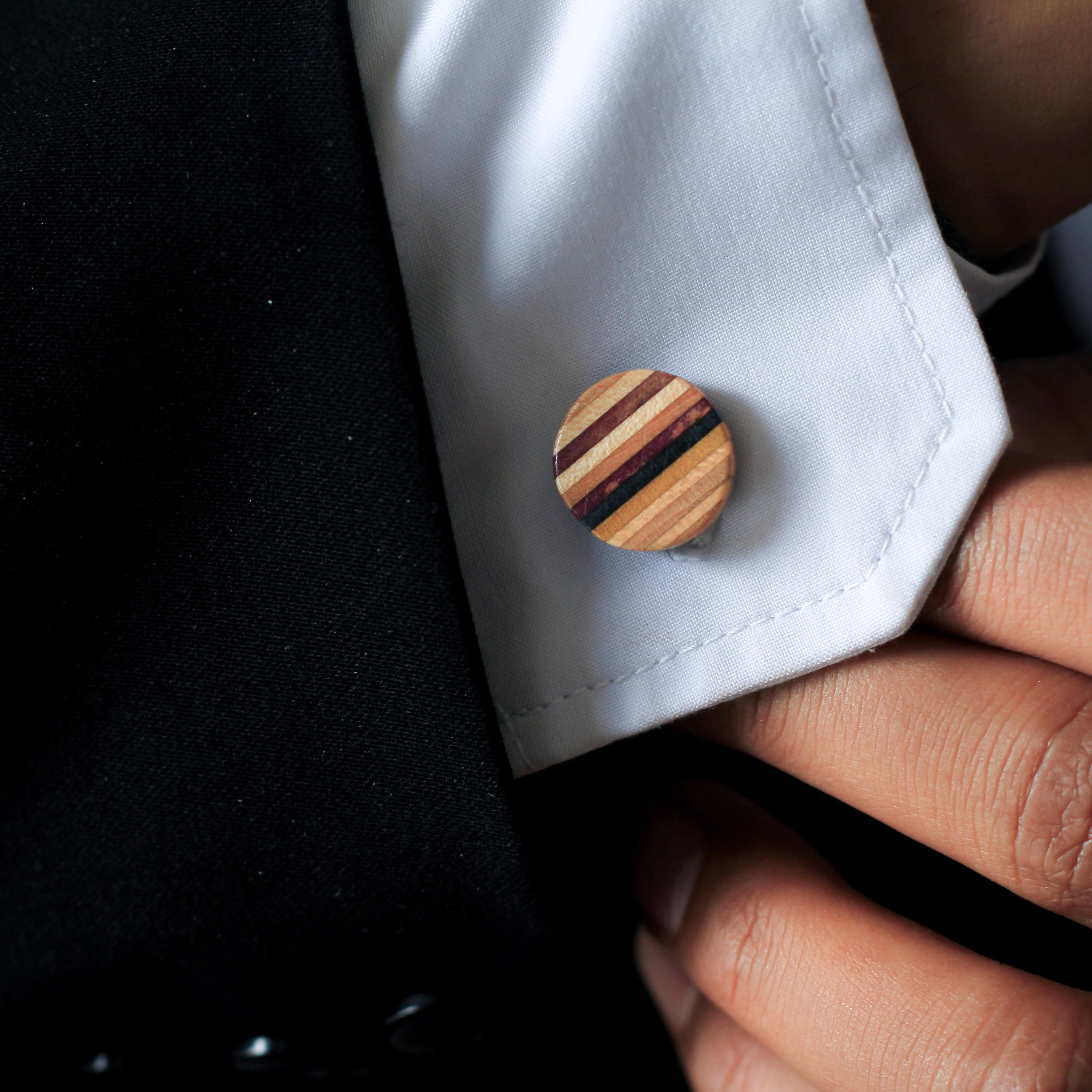 Handcrafted Recycled Skateboard Wooden Round Cufflinks showcasing vibrant colors and unique patterns, presented in a luxury gift box.