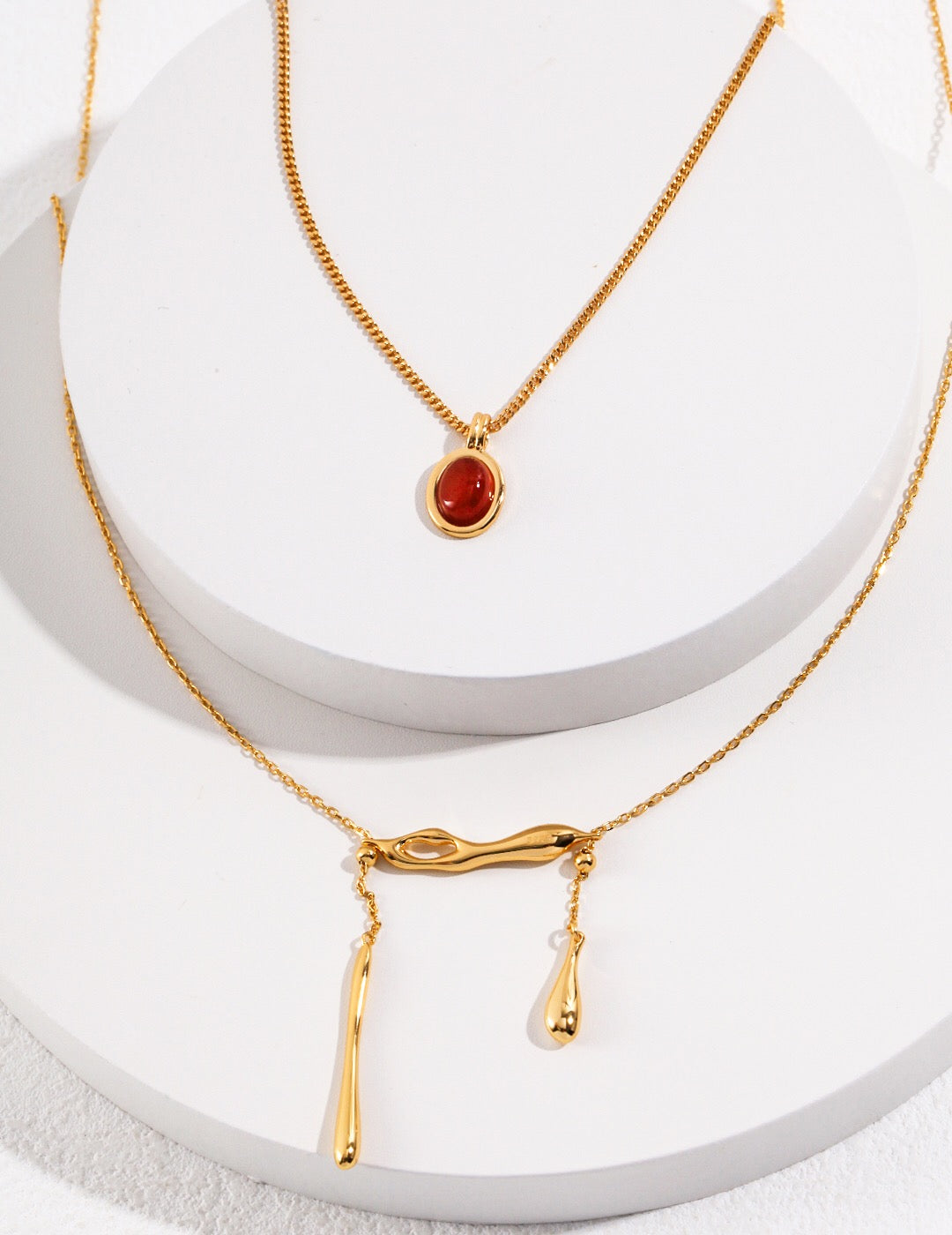 Elegant Red Agate Drop Necklace with gold vermeil chain, showcasing vibrant red stones and adjustable length.