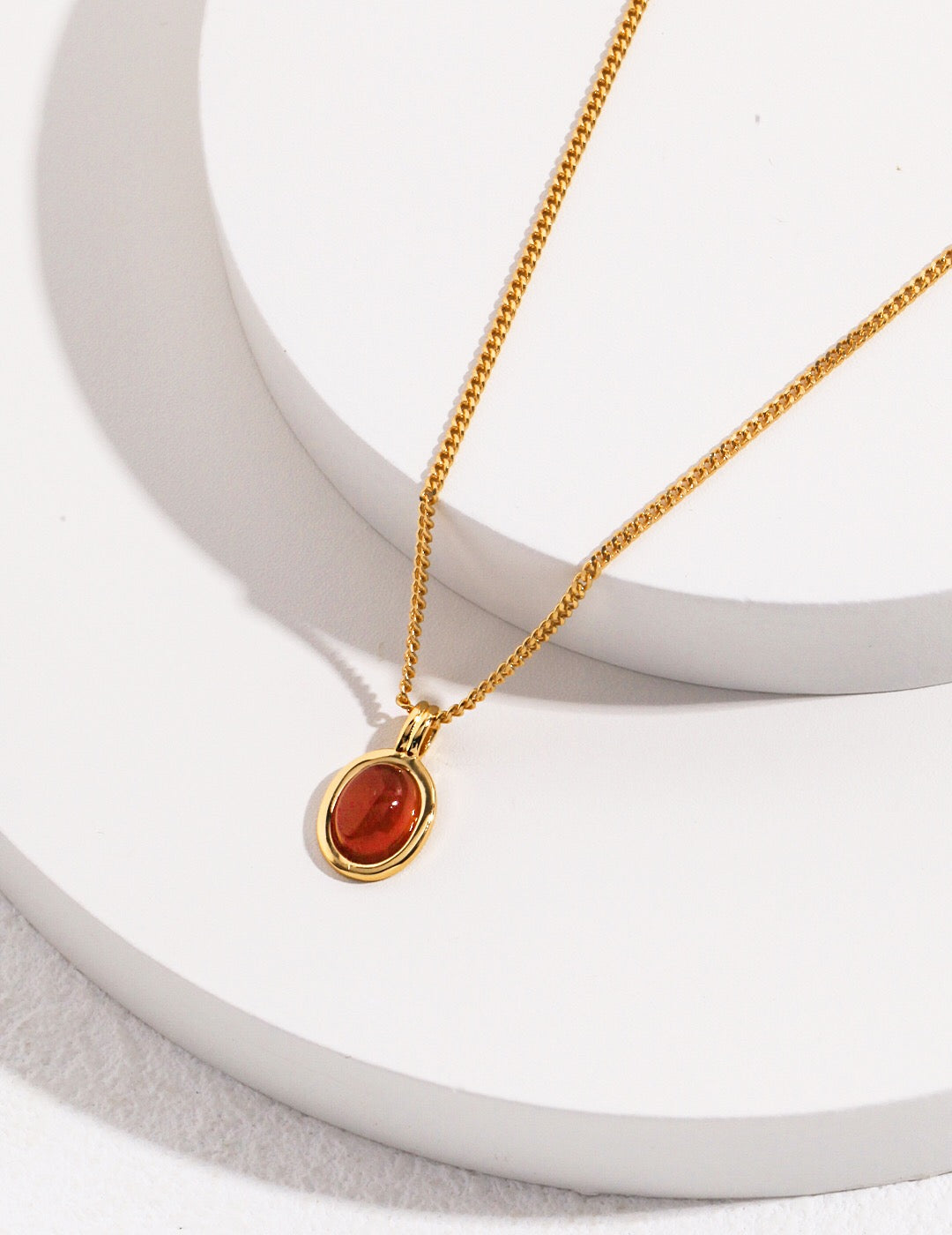 A handcrafted Red Agate Stone Pendant Necklace featuring a vibrant red agate stone set in gold vermeil on sterling silver.