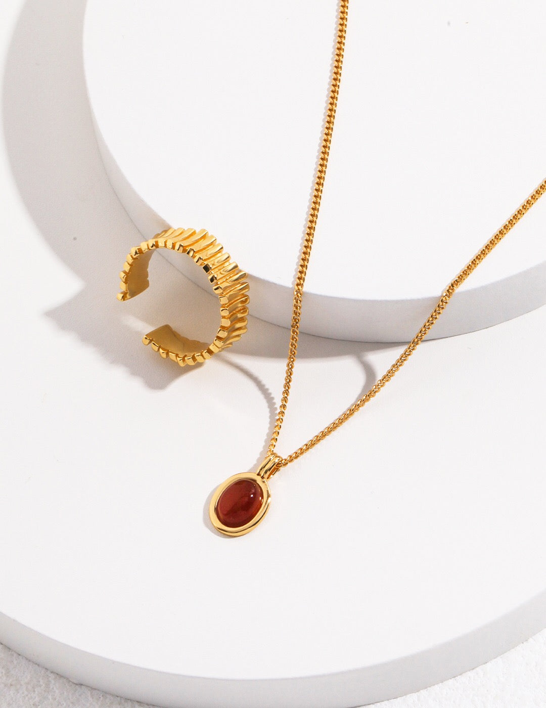 A handcrafted Red Agate Stone Pendant Necklace featuring a vibrant red agate stone set in gold vermeil on sterling silver.