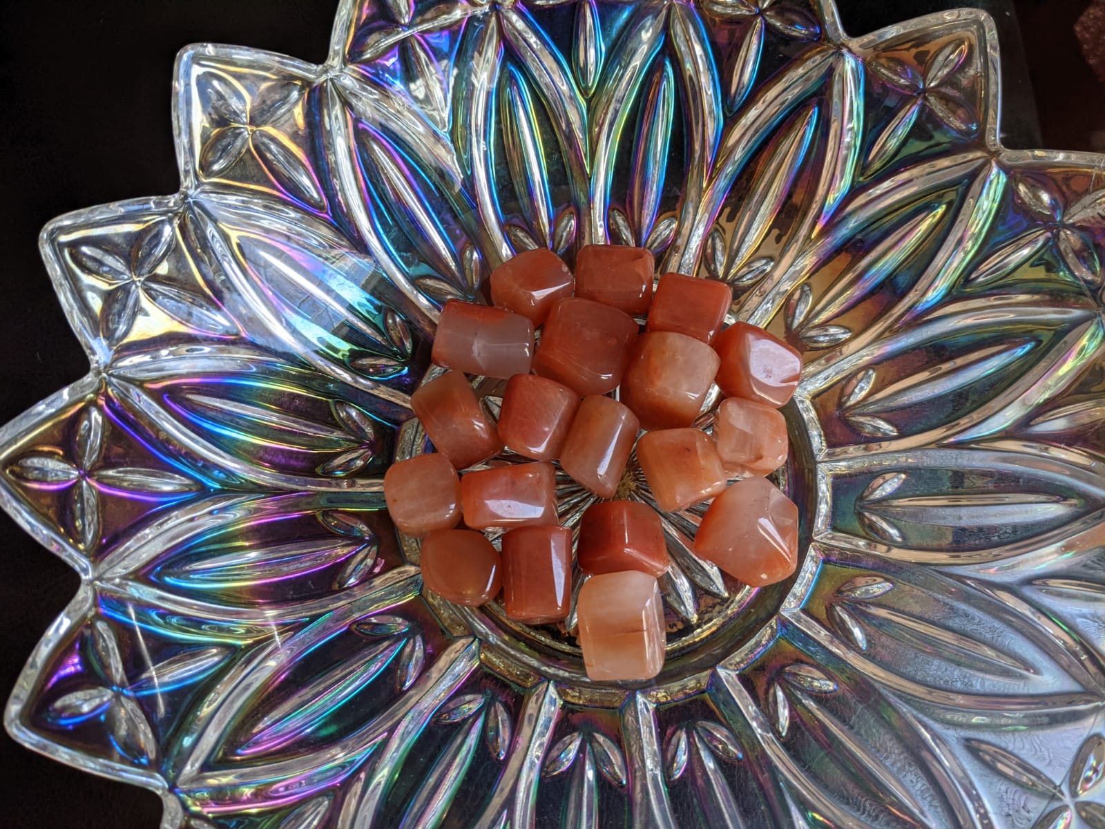 A collection of polished Red Carnelian gemstone tumbles showcasing their vibrant brownish-red color and smooth texture.