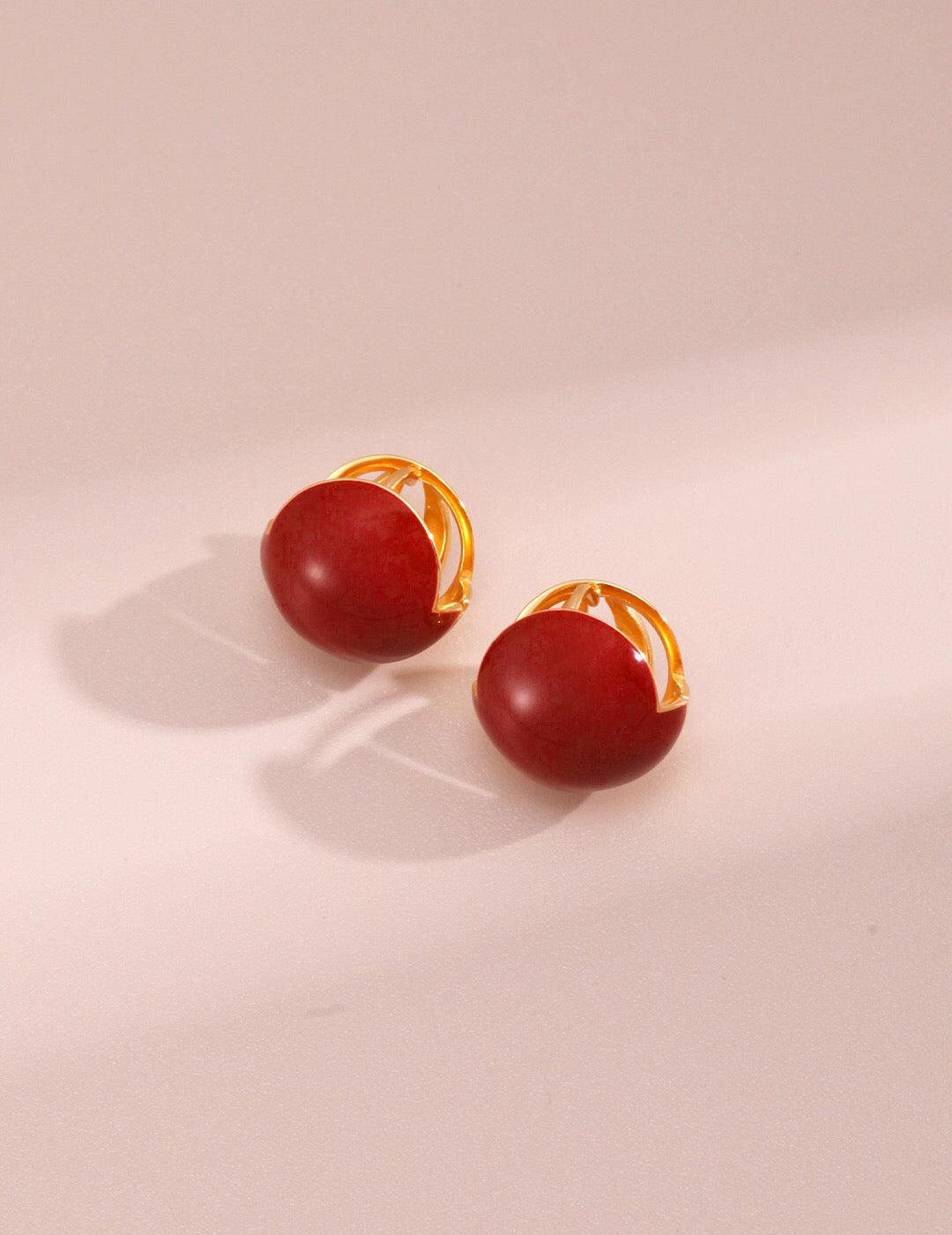 A pair of handmade Red Cherry Enamel Glaze Earrings featuring a vibrant cherry color and gold vermeil accents, elegantly displayed.