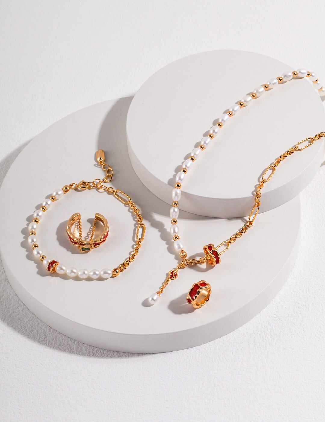 A beautifully handcrafted Red Circle Glaze Pearl Bracelet featuring genuine freshwater pearls and gold vermeil, elegantly displayed on a soft surface.