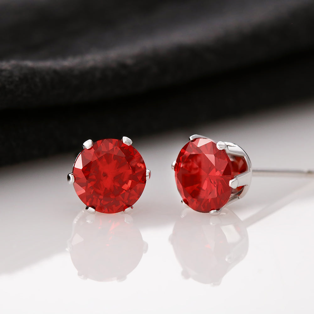 A pair of elegant 6mm red Cubic Zirconia stud earrings set in 14K white gold dipped settings.