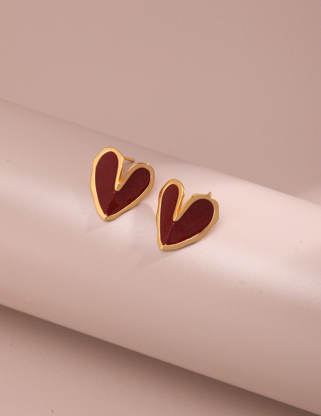 A pair of handmade Red Drip Glaze Folded Love Heart Earrings featuring a unique drip glaze finish and gold vermeil accents.