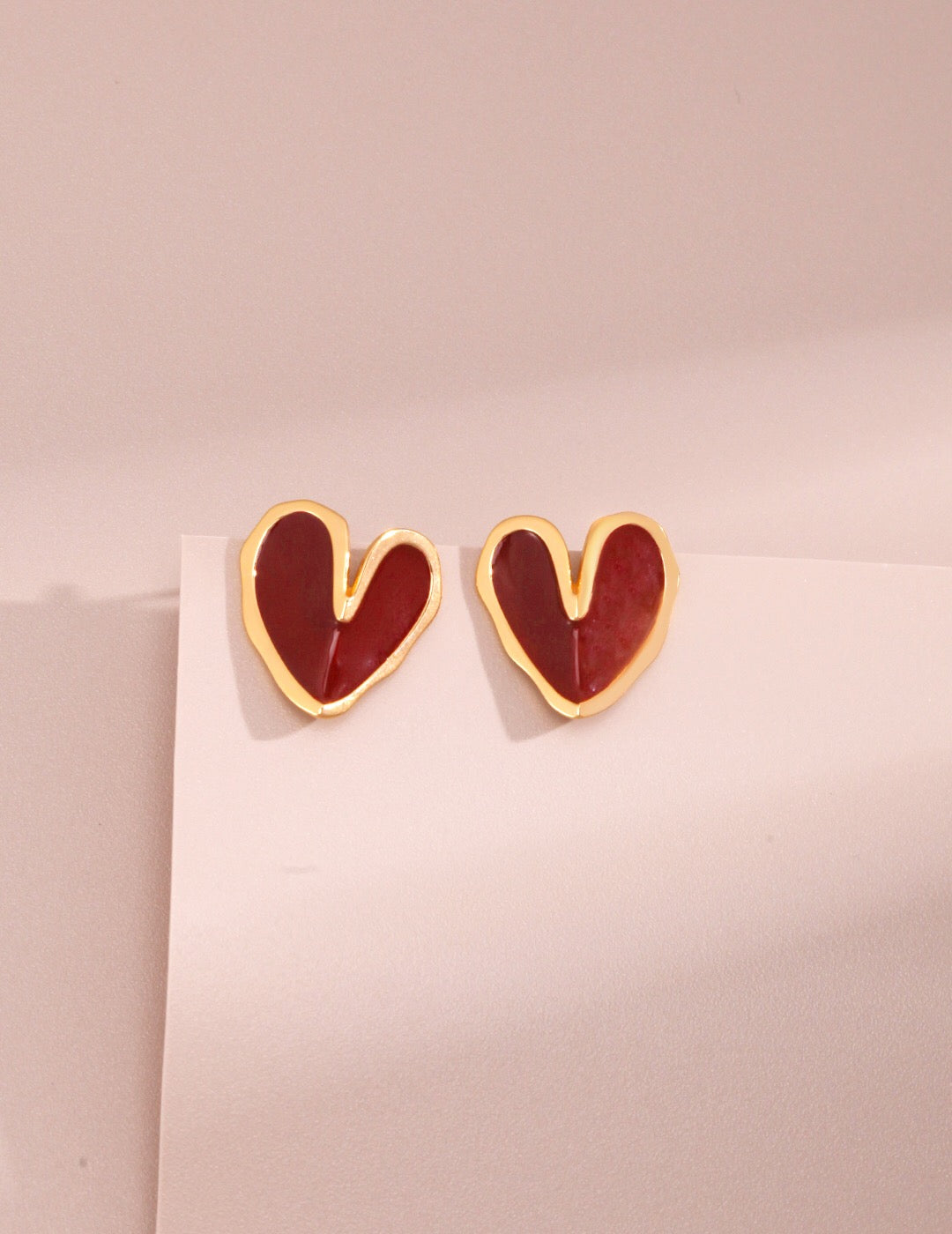 A pair of handmade Red Drip Glaze Folded Love Heart Earrings featuring a unique drip glaze finish and gold vermeil accents.