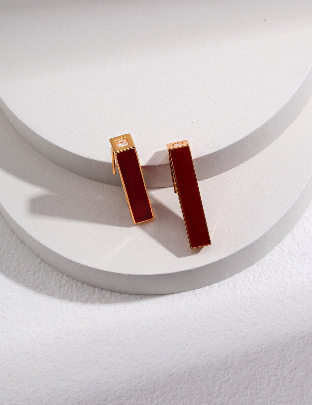 A pair of handmade Red Drip Glaze Pillar Stud Earrings featuring a vibrant drip glaze finish and gold vermeil accents.