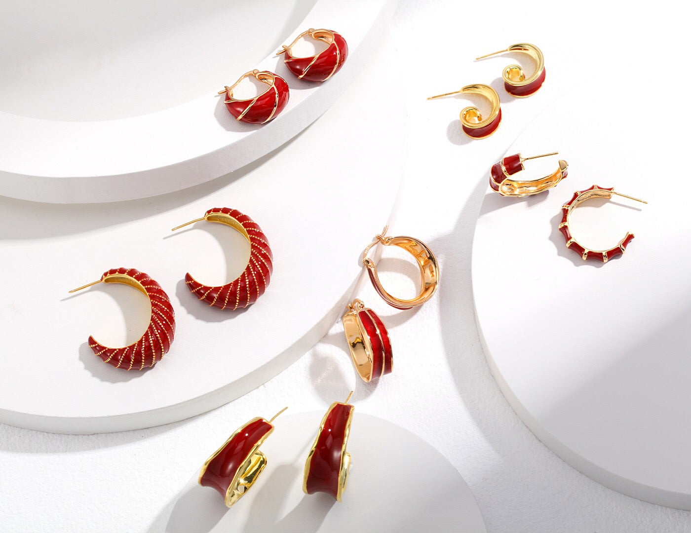 A pair of handmade red enamel glaze bamboo earrings with gold vermeil detailing, showcasing their vibrant color and elegant design.