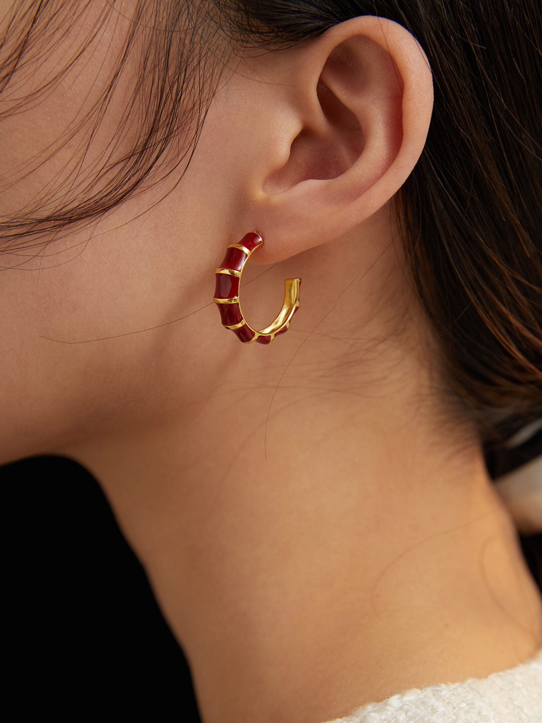 A pair of handmade red enamel glaze bamboo earrings with gold vermeil detailing, showcasing their vibrant color and elegant design.