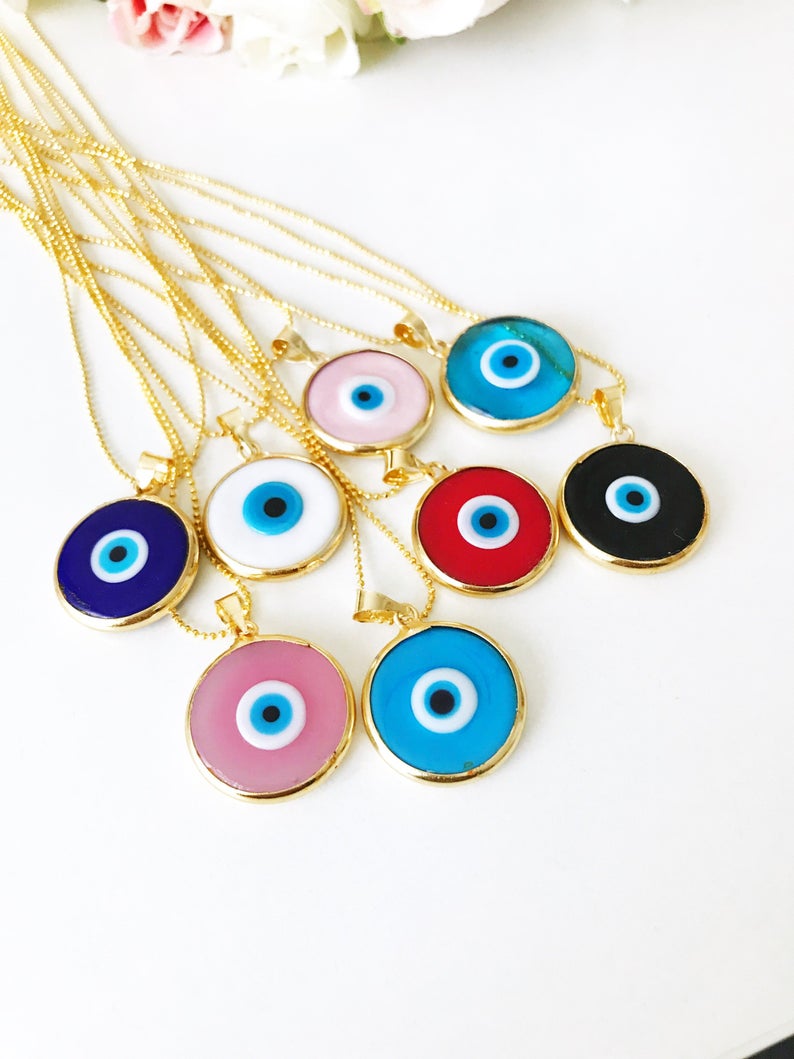 A beautiful collection of Red Evil Eye Jewelry including a bracelet and necklace made with red Murano glass and gold accents, symbolizing protection and good luck.