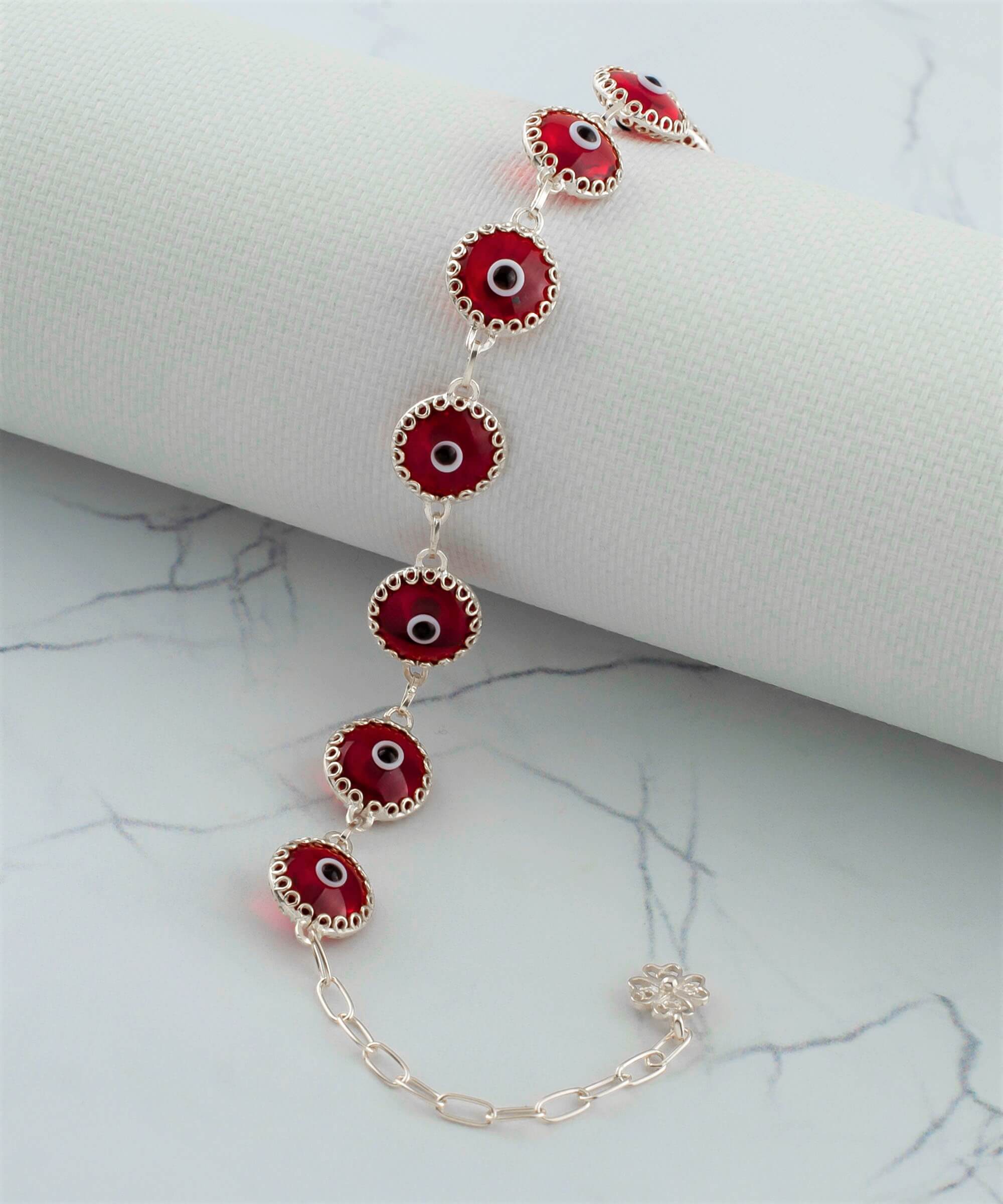 Red Evil Eye Sterling Silver Adjustable Link Bracelet featuring a strong rolo chain and ten beads wrapped in silver prongs.