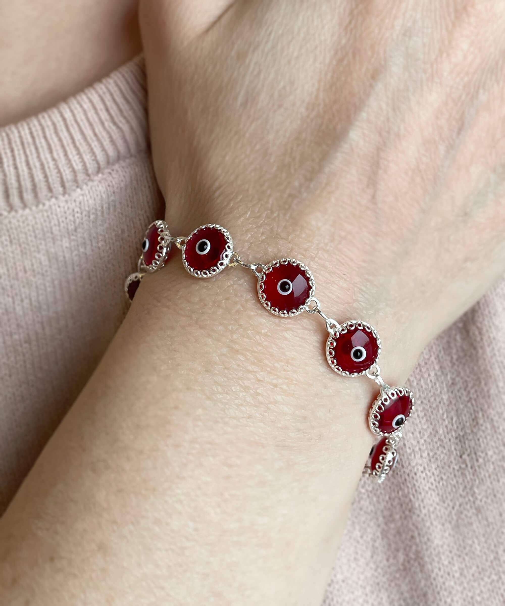 Red Evil Eye Sterling Silver Adjustable Link Bracelet featuring a strong rolo chain and ten beads wrapped in silver prongs.