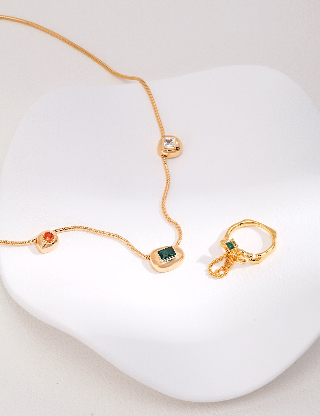 A beautiful handmade Red Green White Zircon Necklace featuring gold vermeil and vibrant zircon stones, elegantly displayed on a soft background.