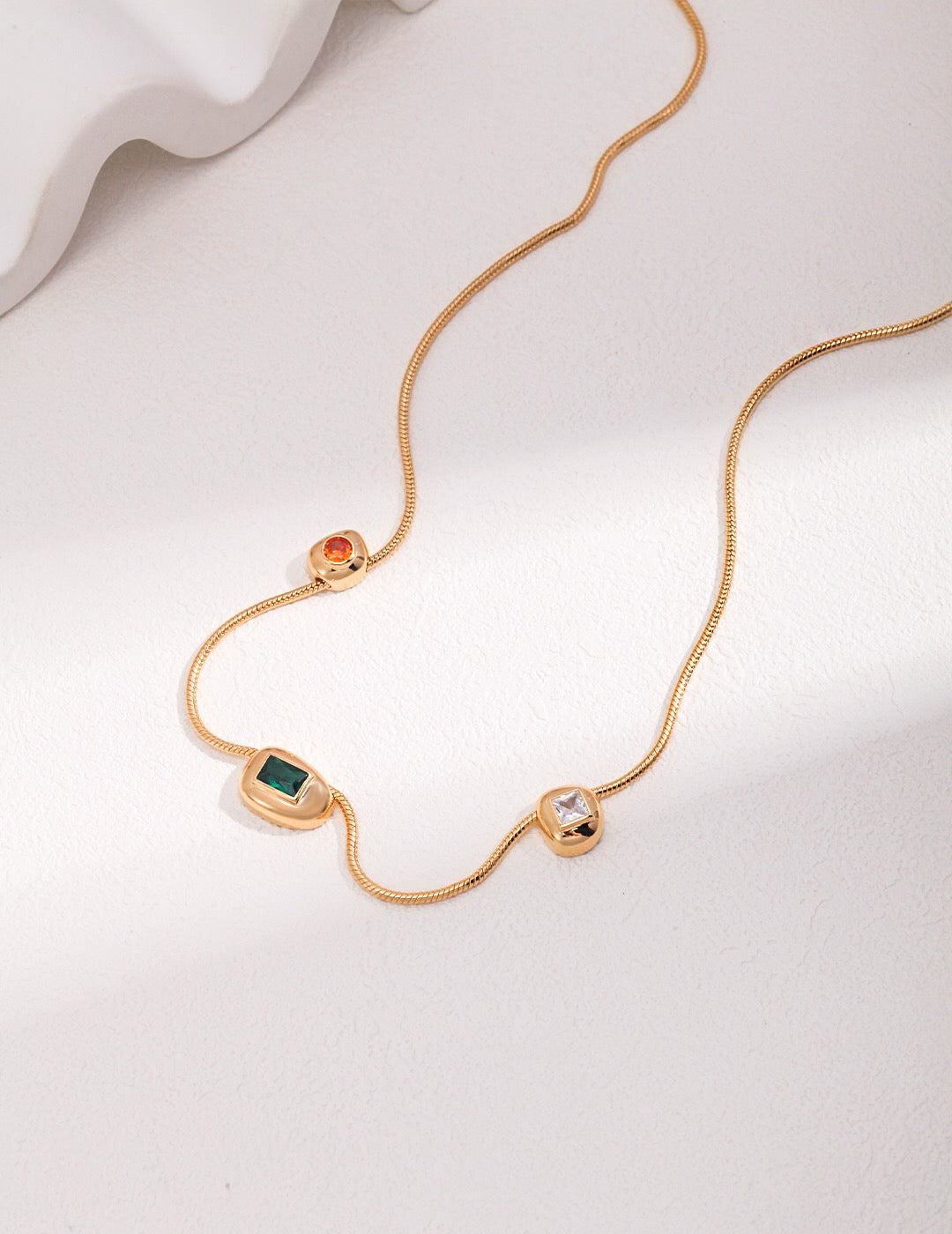 A beautiful handmade Red Green White Zircon Necklace featuring gold vermeil and vibrant zircon stones, elegantly displayed on a soft background.