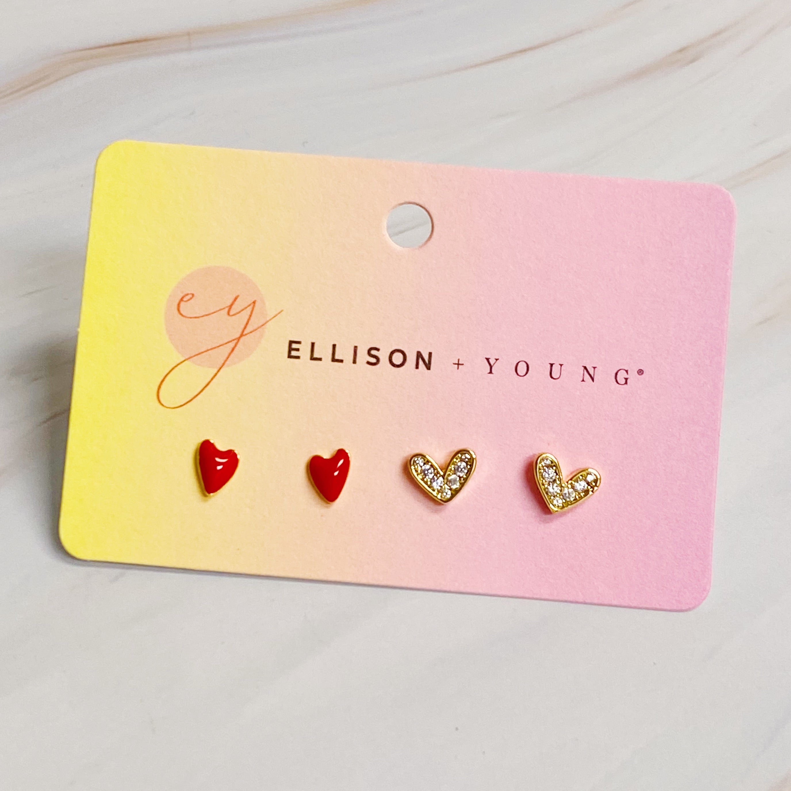 A set of two red heart earrings, one simple and one sparkling, crafted from 18k gold plated brass.