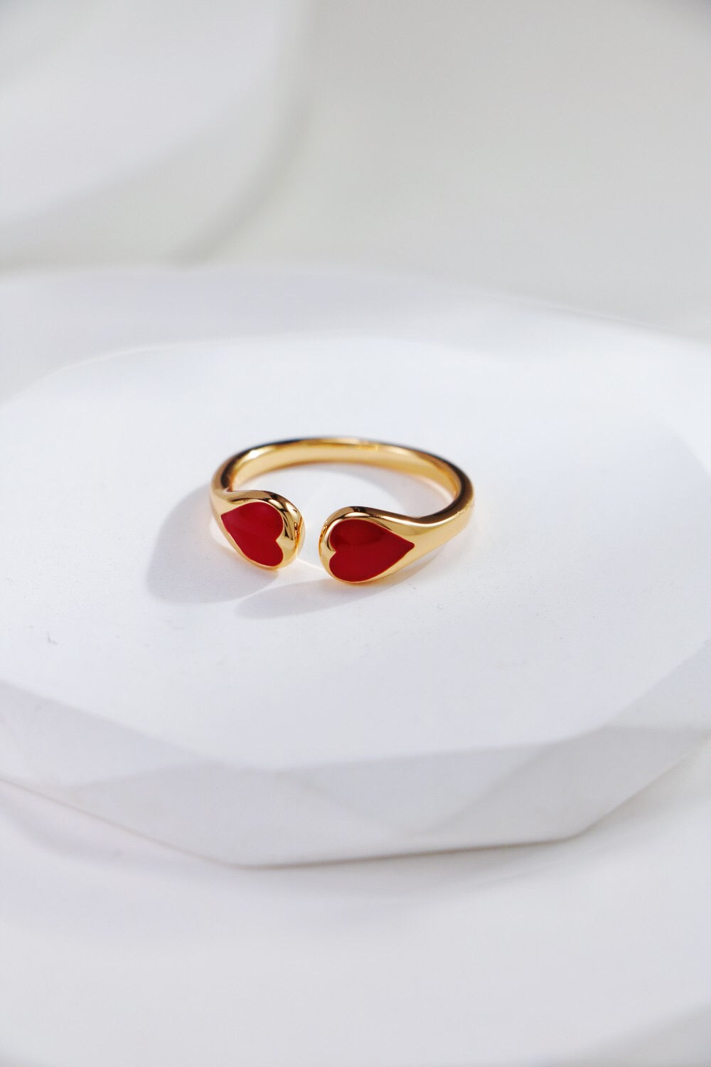 A stunning red heart shaped ring made of gold vermeil, showcasing its elegant design and craftsmanship.