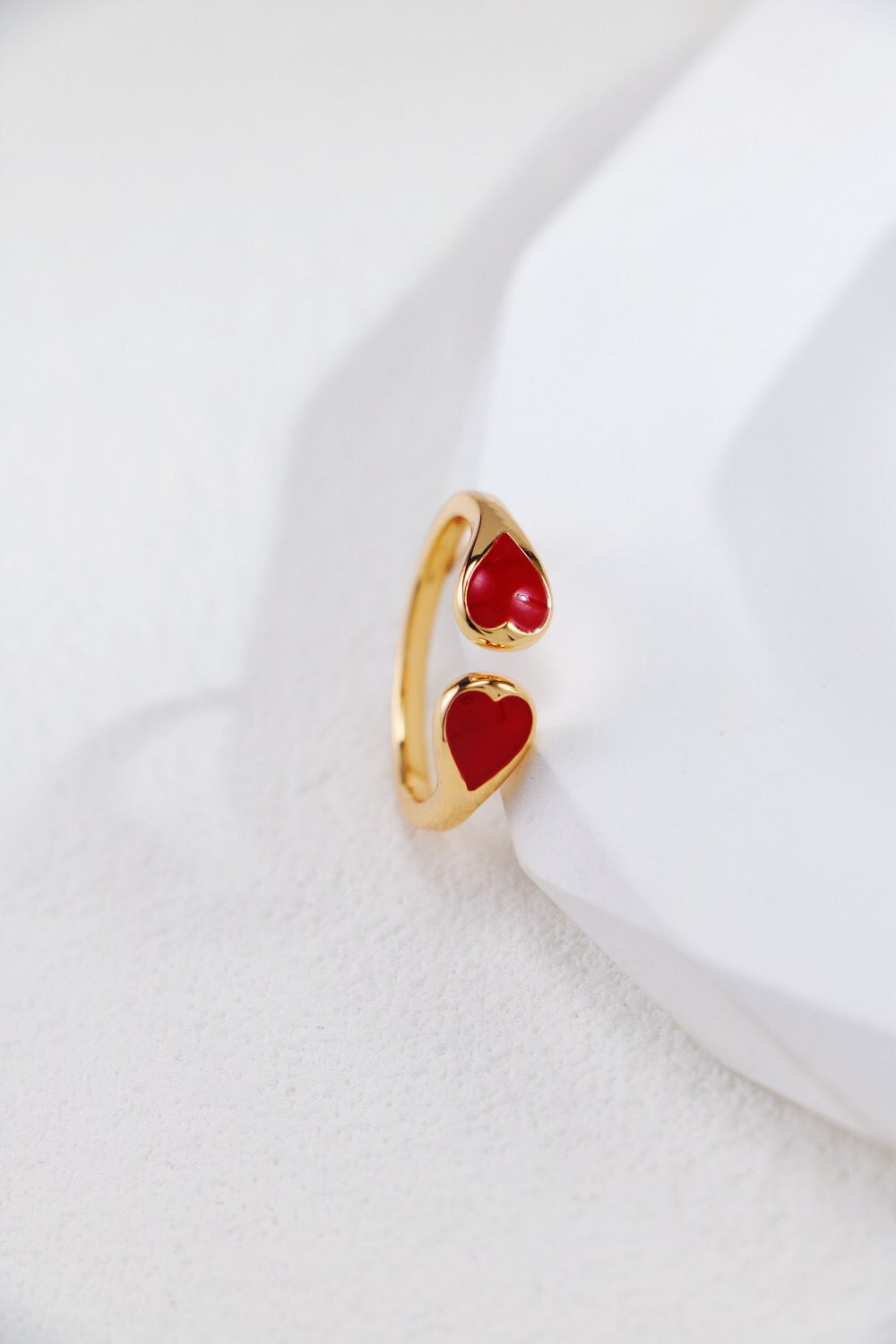 A stunning red heart shaped ring made of gold vermeil, showcasing its elegant design and craftsmanship.