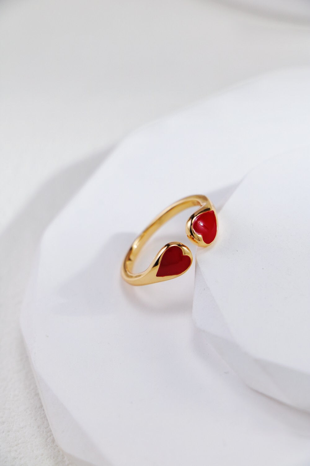 A stunning red heart shaped ring made of gold vermeil, showcasing its elegant design and craftsmanship.