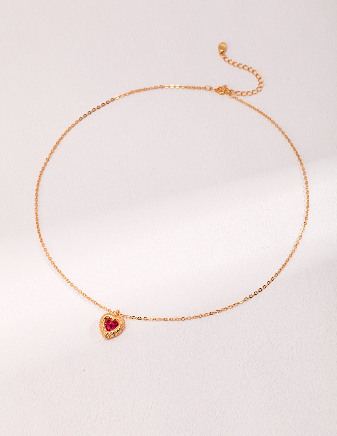 A beautiful Red Steel Jade Love Zircon Necklace featuring a heart pendant, crafted from 18ct gold vermeil and zircon stones.