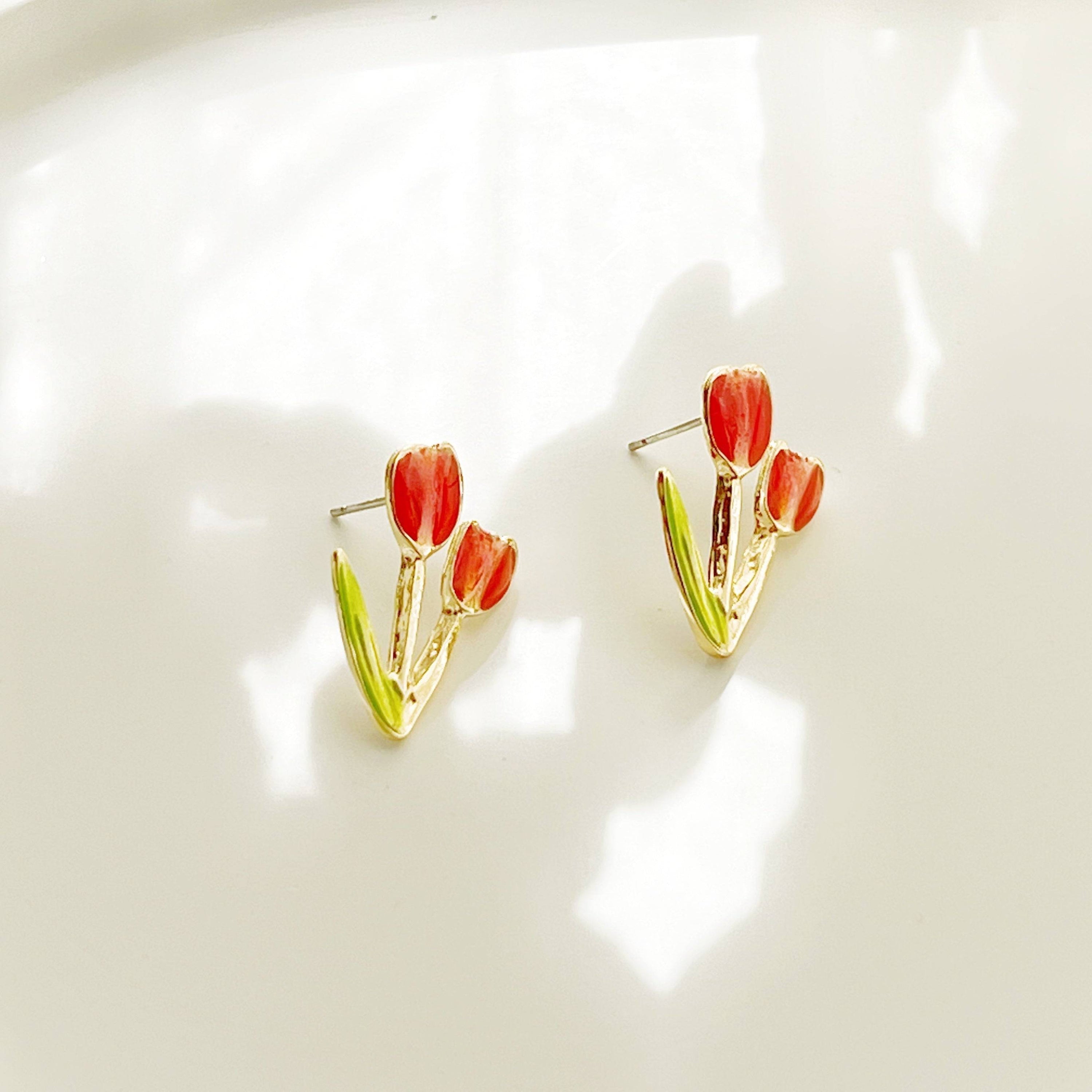 A pair of elegant red tulip stud earrings made of gold plated bronze and sterling silver, beautifully designed for spring fashion.