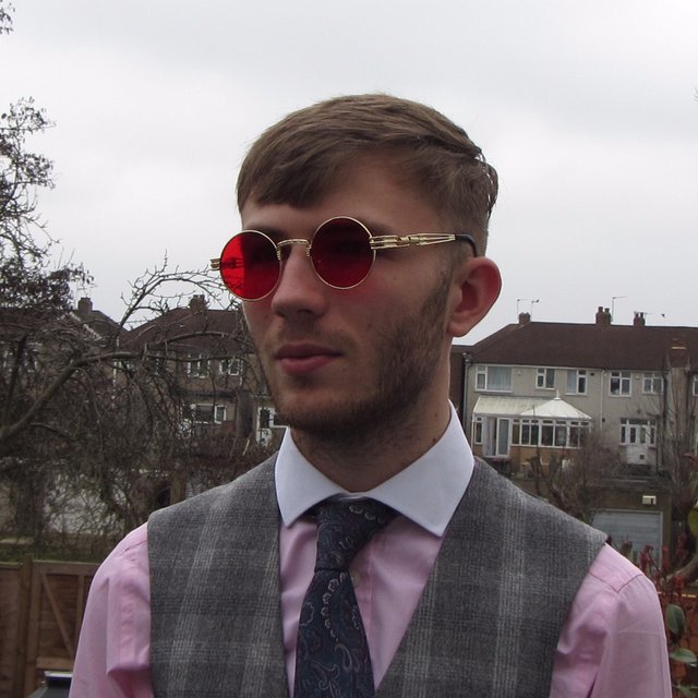 Stylish red and gold sunglasses made from metal and acrylic, featuring a non-tarnish finish and unisex design.