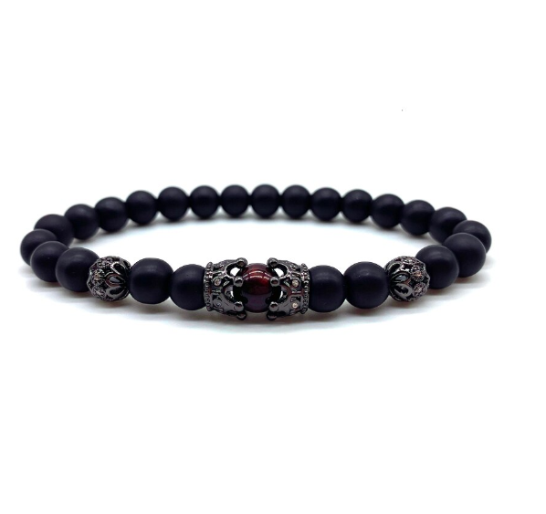 Resilient Steel Bracelet featuring matte black beads and a gold lion pendant, showcasing a bold and elegant design.