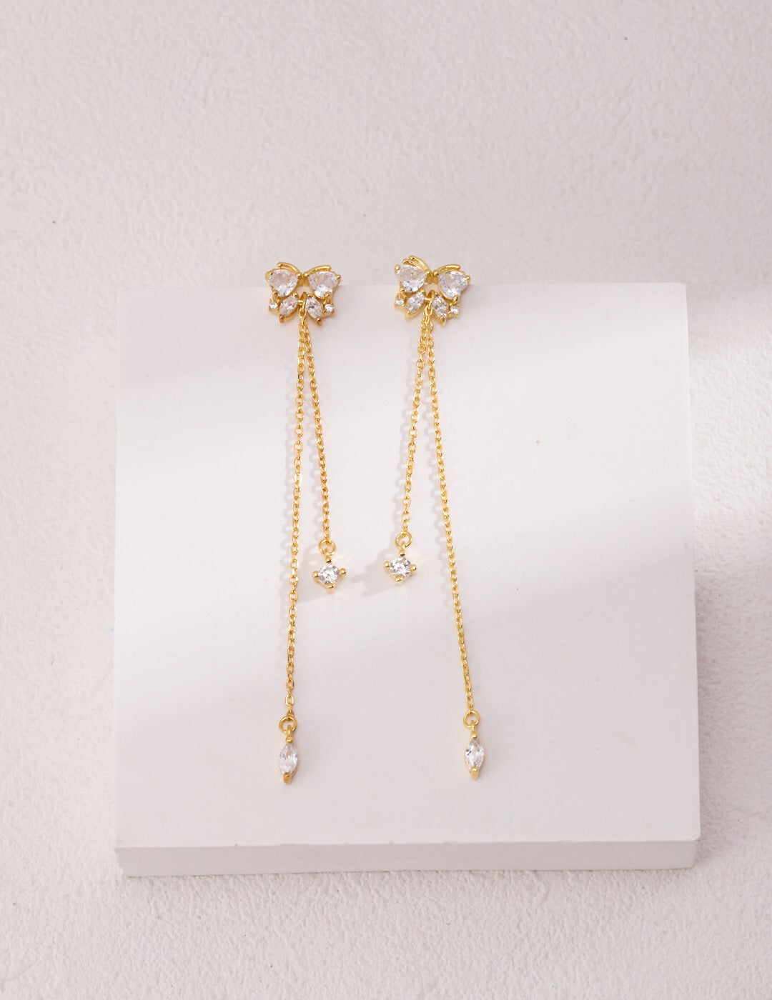 Elegant Rhinestone Butterfly Tassel Earrings featuring zircon stones and gold vermeil, showcasing intricate design and shimmering details.