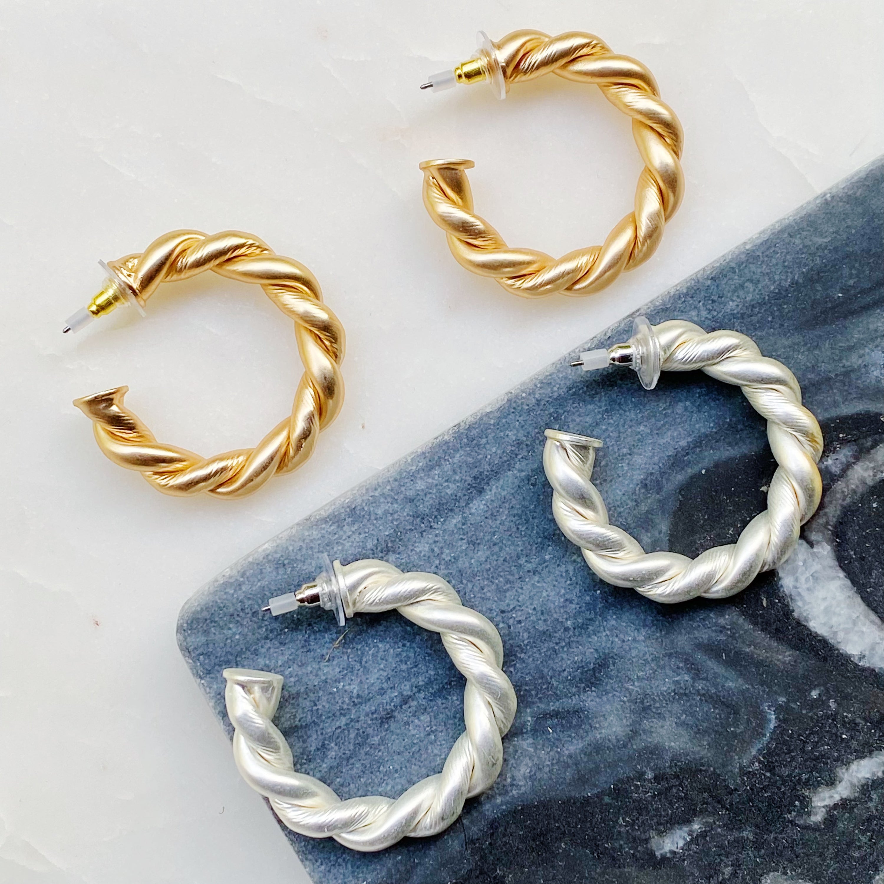 Riley Braided Hoop Earrings featuring a stylish twisted design with a matt finish, measuring approximately 1.5 inches in diameter.