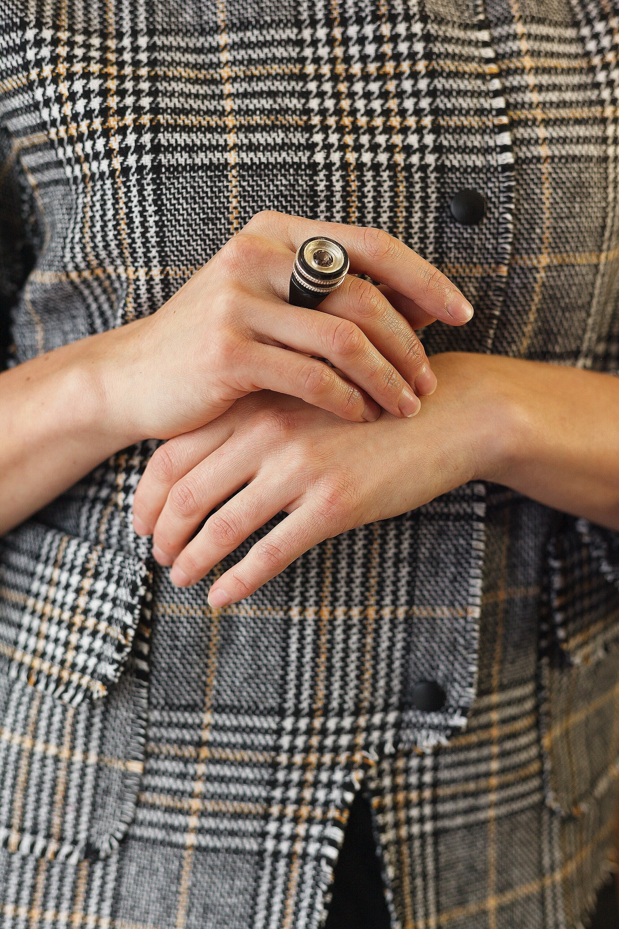 Handmade black ring featuring silver inlays and rauchtopaz stone, showcasing unique craftsmanship.