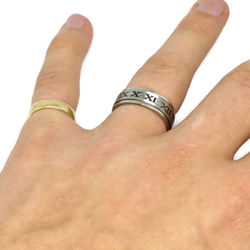 A stylish Roman Numerals Spinning Band Ring made of stainless steel, showcasing its unique spinning feature and bold 1.8cm width.