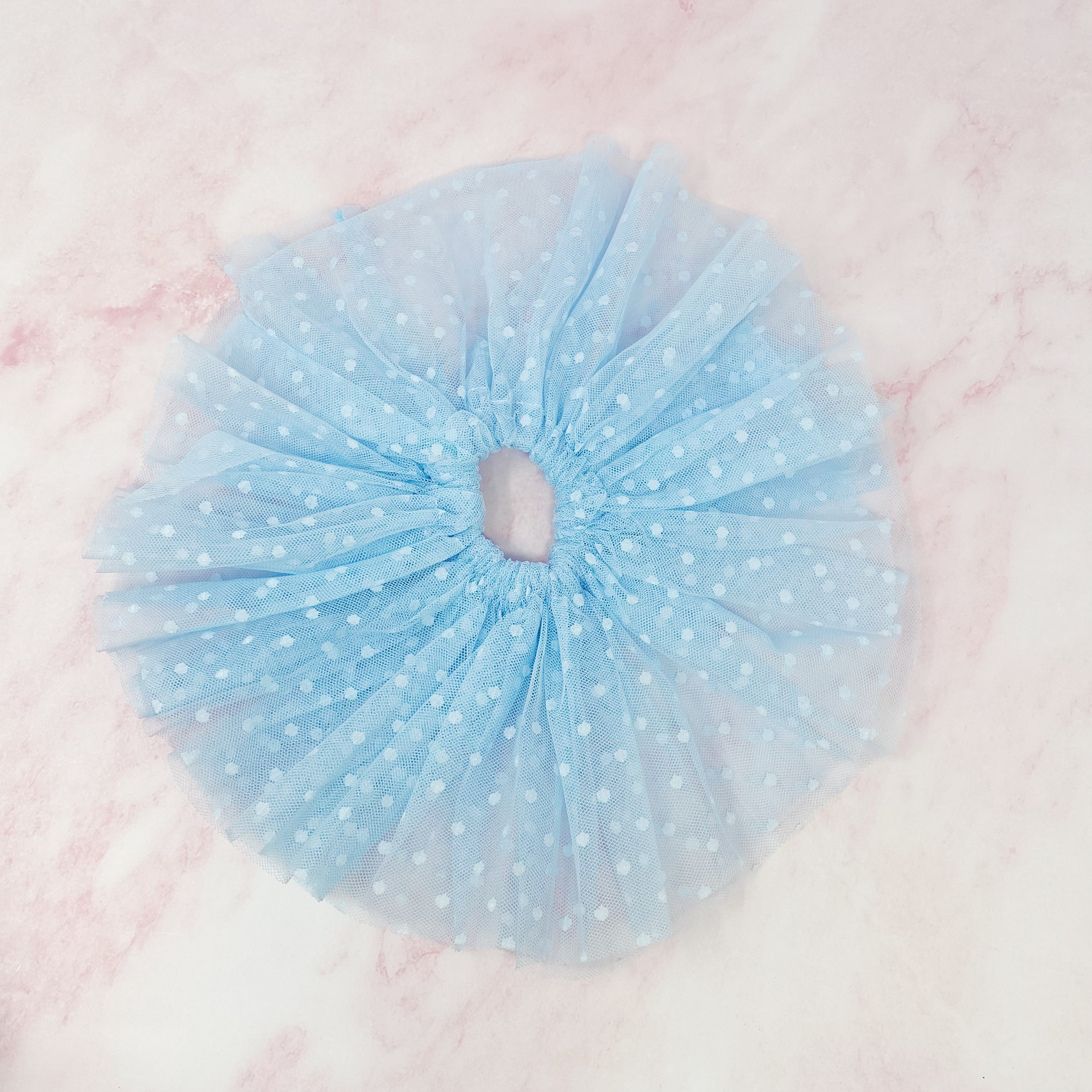 A delicate Romantic Tule Hair Scrunch featuring soft tulle fabric, perfect for adding elegance to hairstyles.