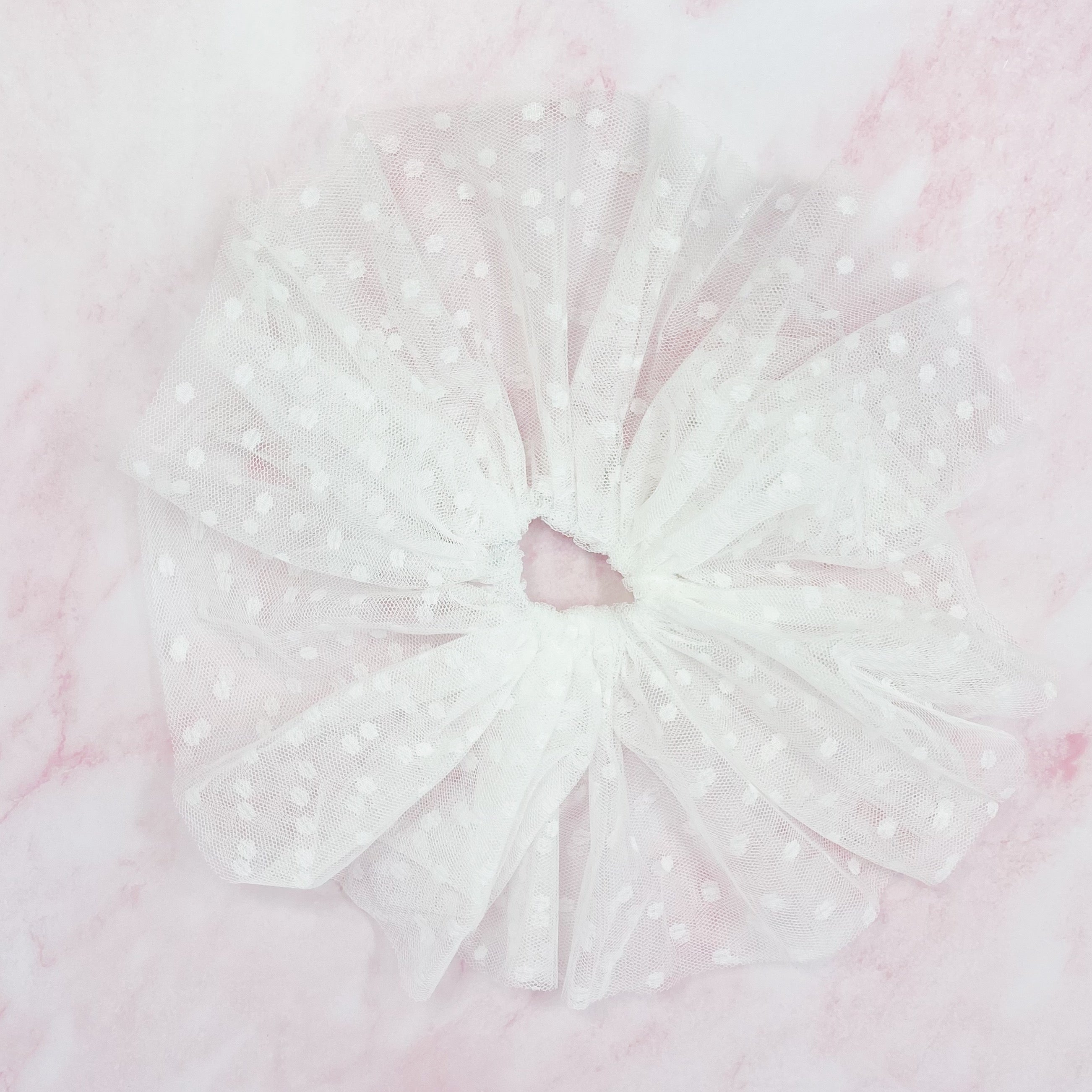 A delicate Romantic Tule Hair Scrunch featuring soft tulle fabric, perfect for adding elegance to hairstyles.