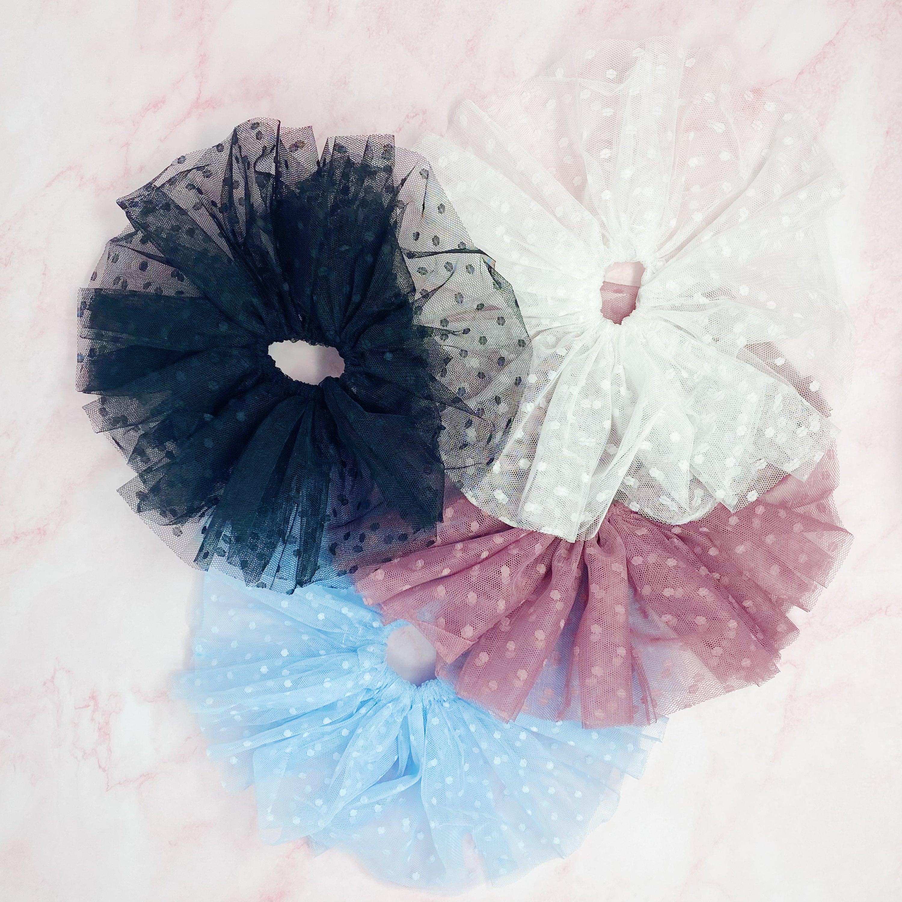 A delicate Romantic Tule Hair Scrunch featuring soft tulle fabric, perfect for adding elegance to hairstyles.