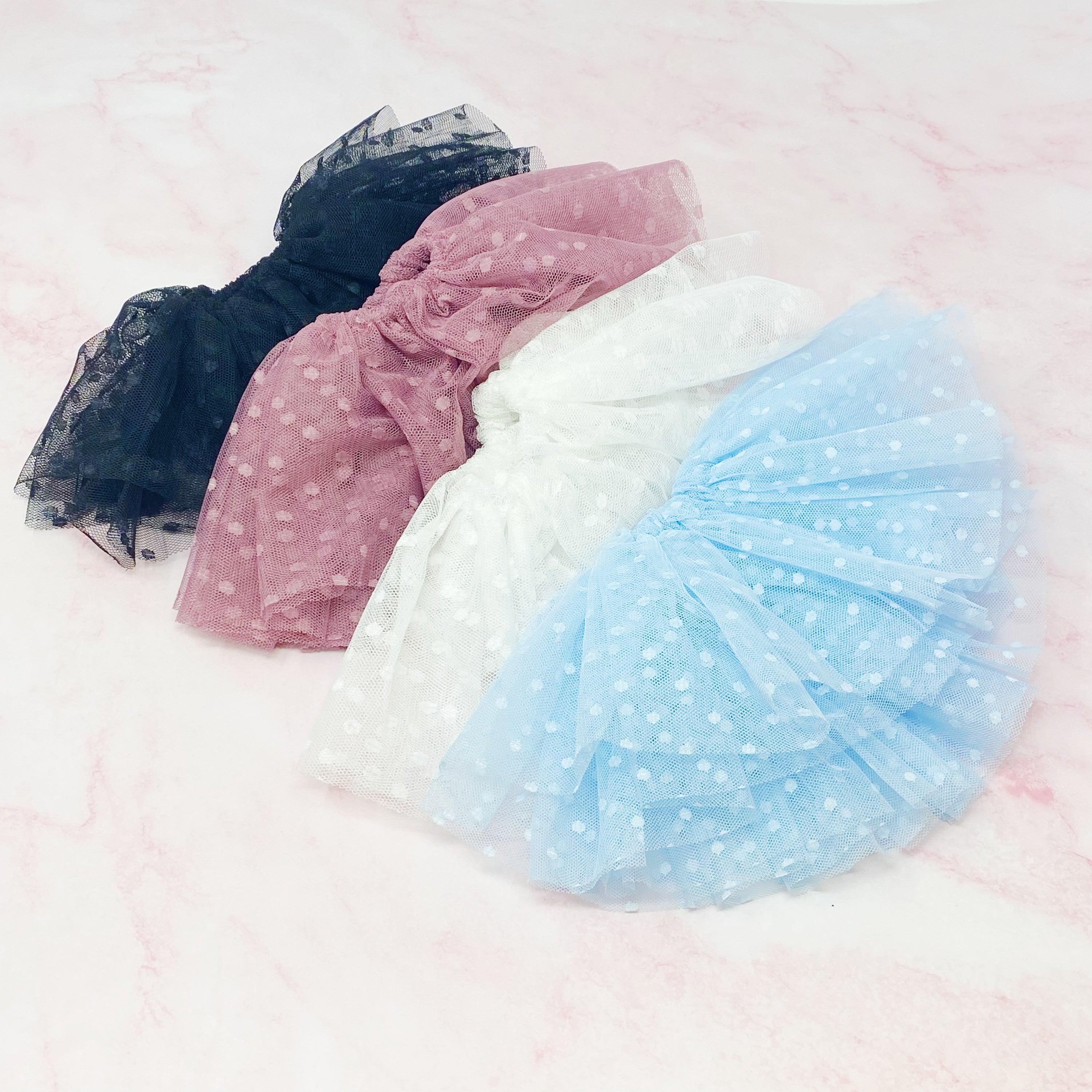 A delicate Romantic Tule Hair Scrunch featuring soft tulle fabric, perfect for adding elegance to hairstyles.