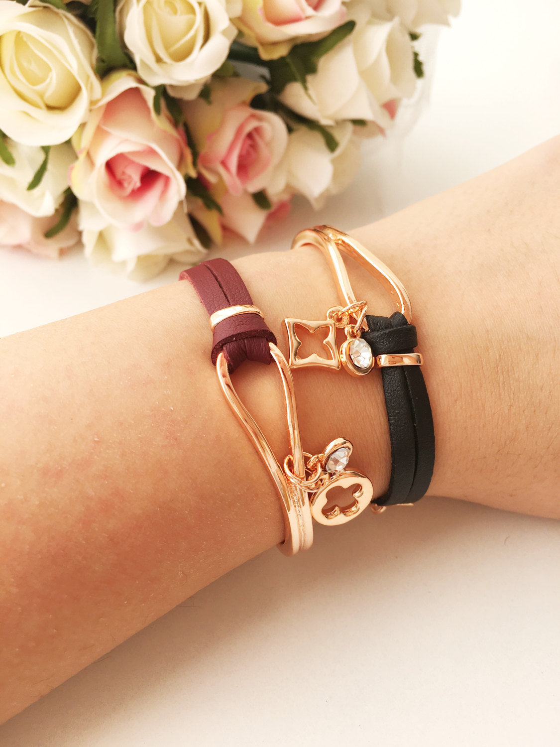 Elegant rose gold leather bracelet featuring a clover charm, adjustable design, and tarnish-resistant stainless steel material.