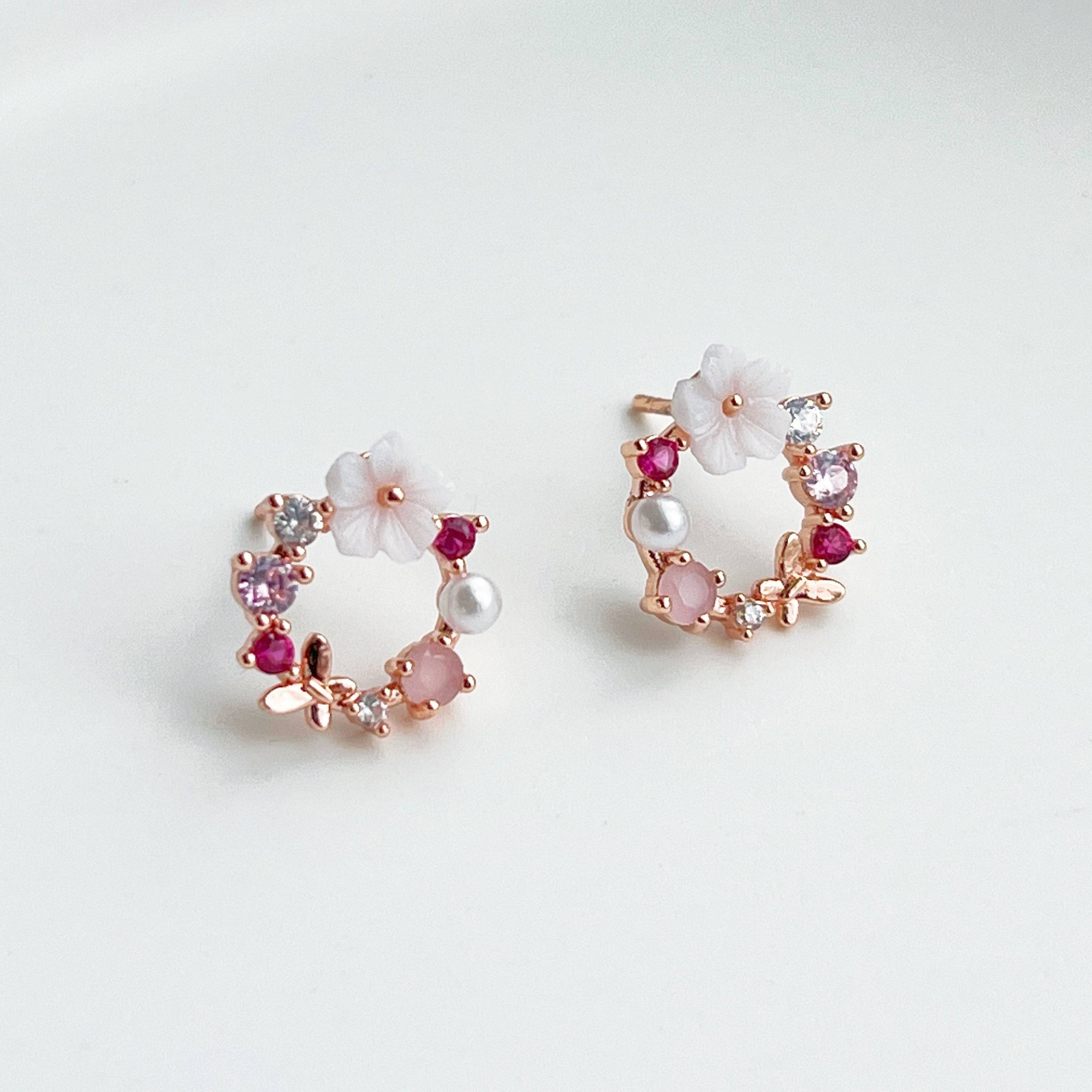 Rose gold wreath earrings featuring pink crystals and pearls, elegantly designed for a timeless look.