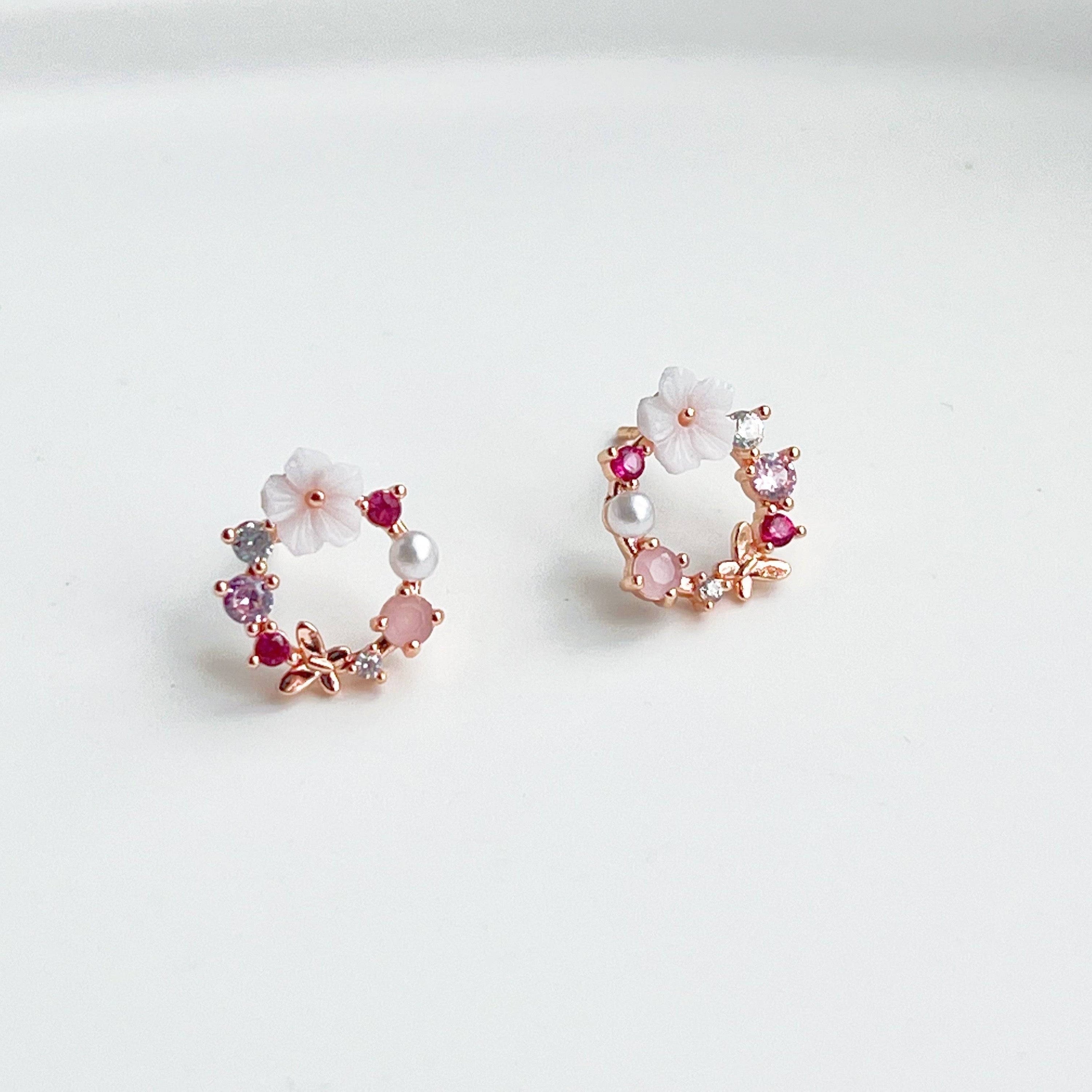 Rose gold wreath earrings featuring pink crystals and pearls, elegantly designed for a timeless look.