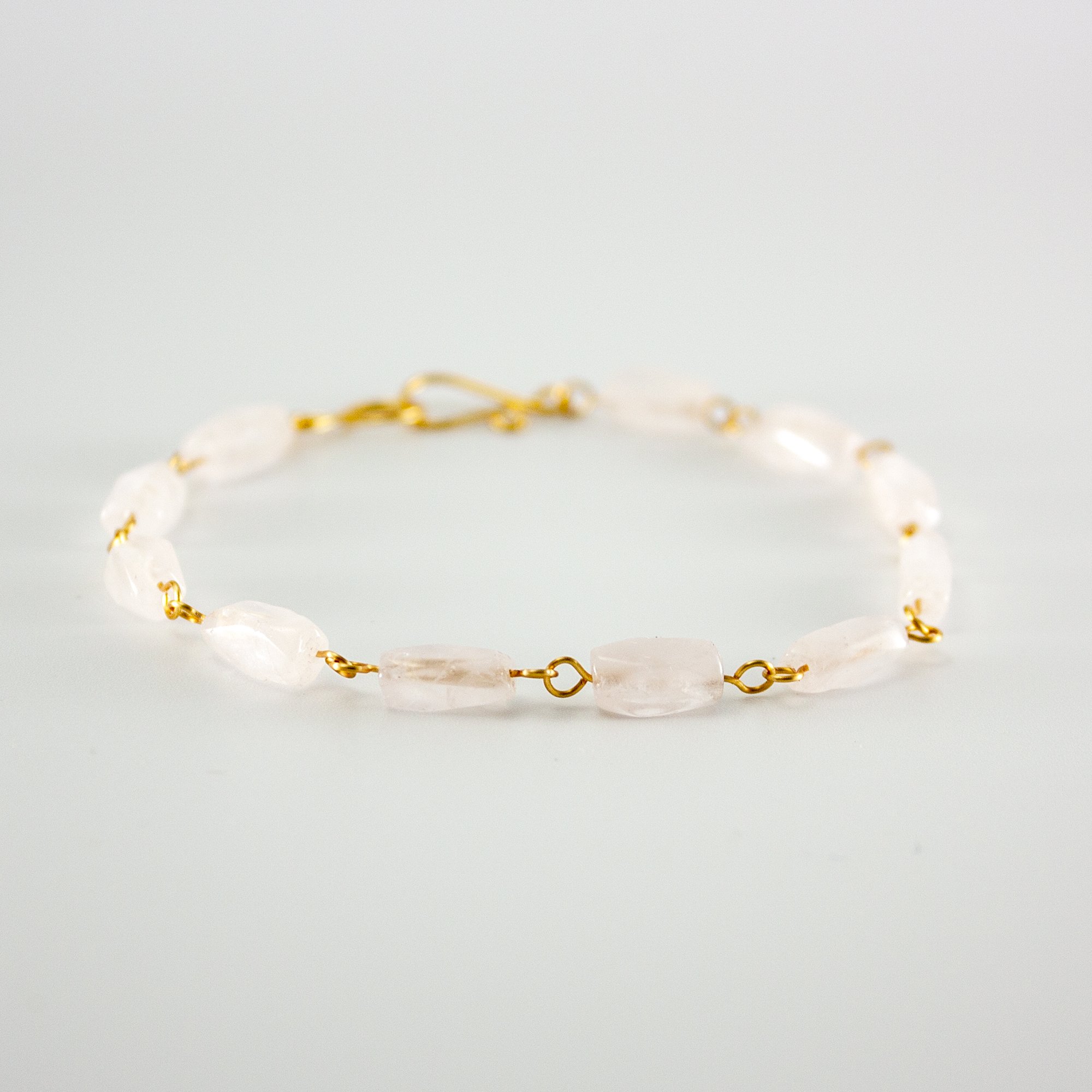 Elegant Rose Quartz Rectangular Gold Link Bracelet featuring soft pink gemstones and silver-plated copper links.